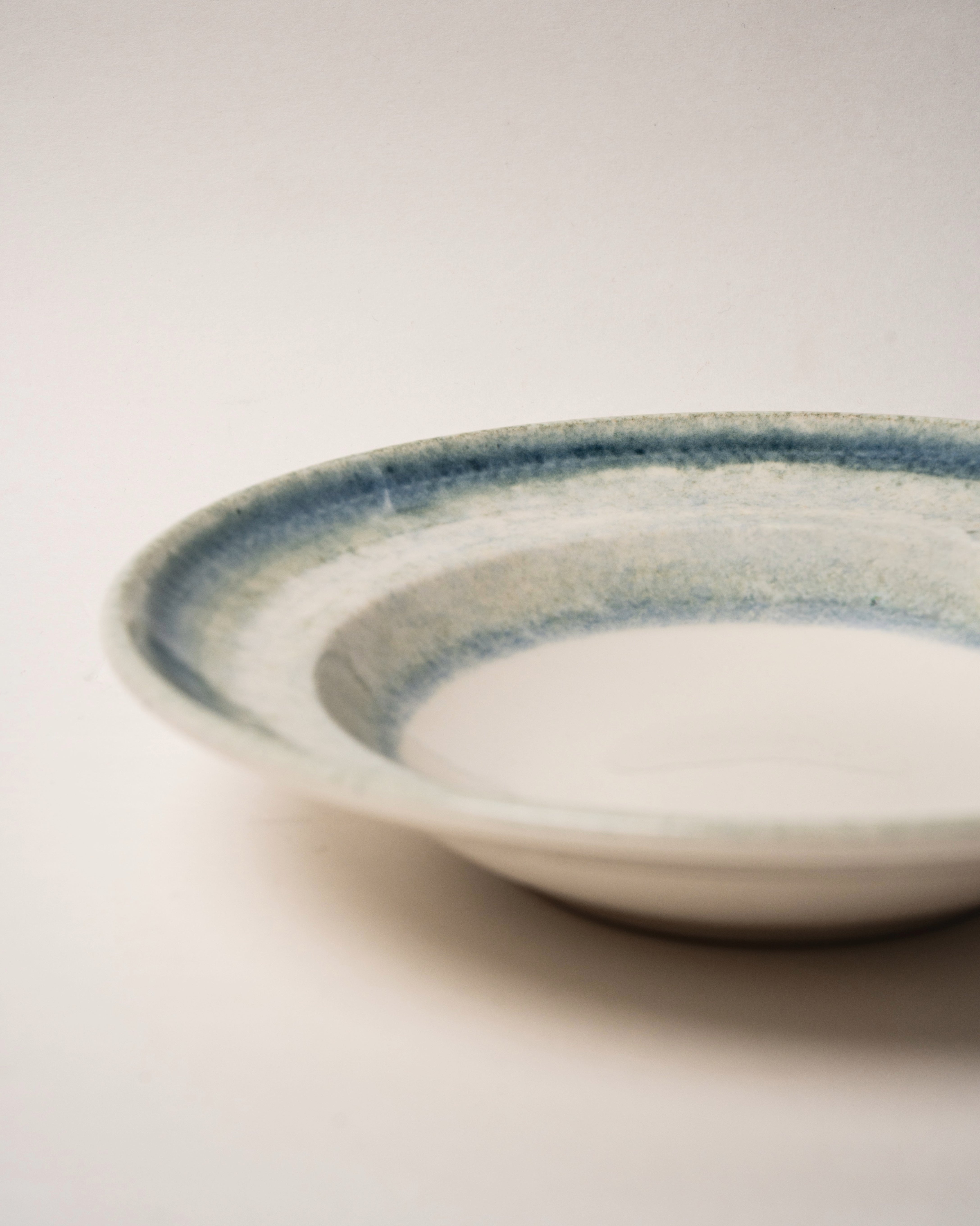 Angled view of Atlantis porcelain bistro bowl showing rim and glaze detail