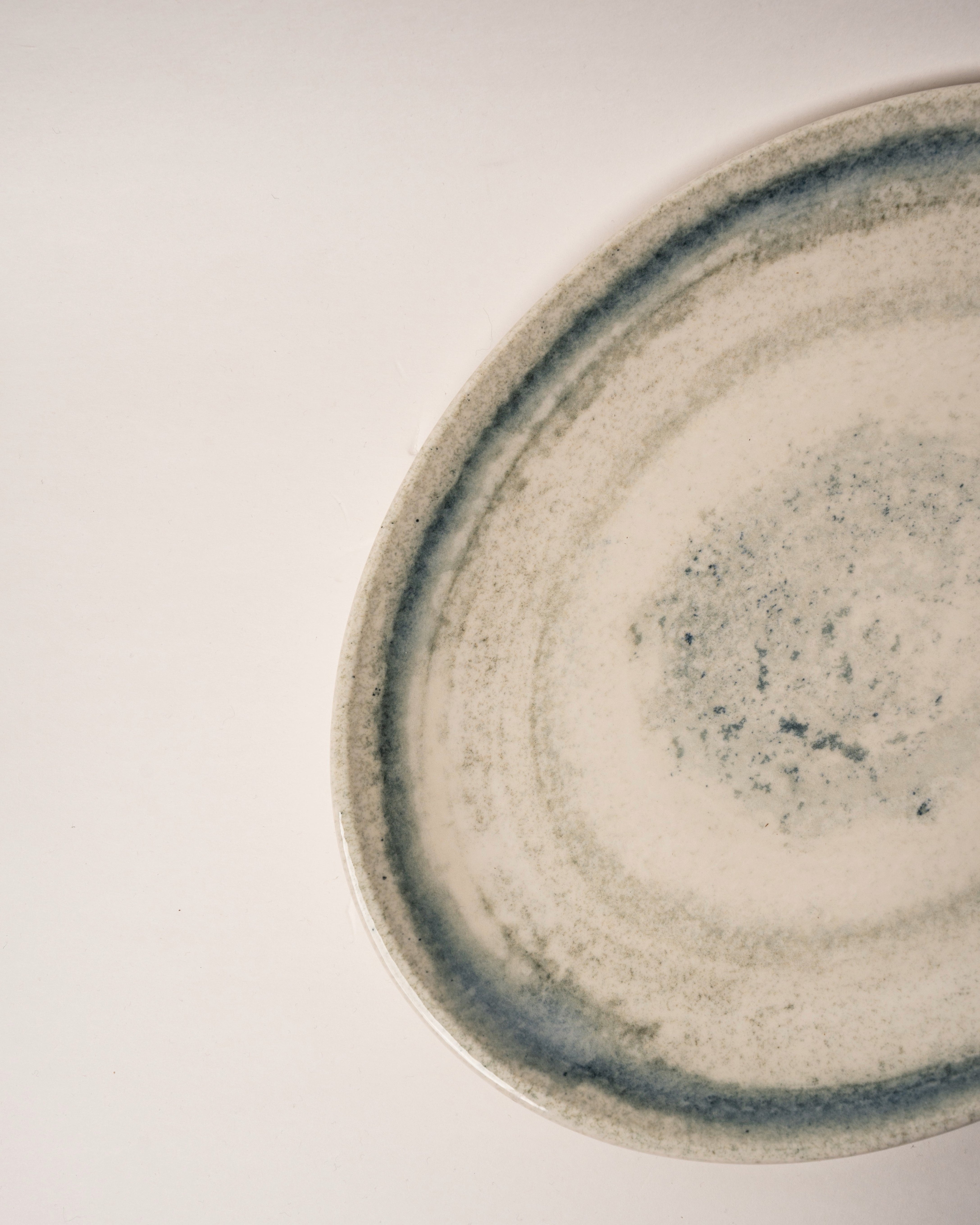 Angled view of Atlantis porcelain oval platter showing rim and glaze detail