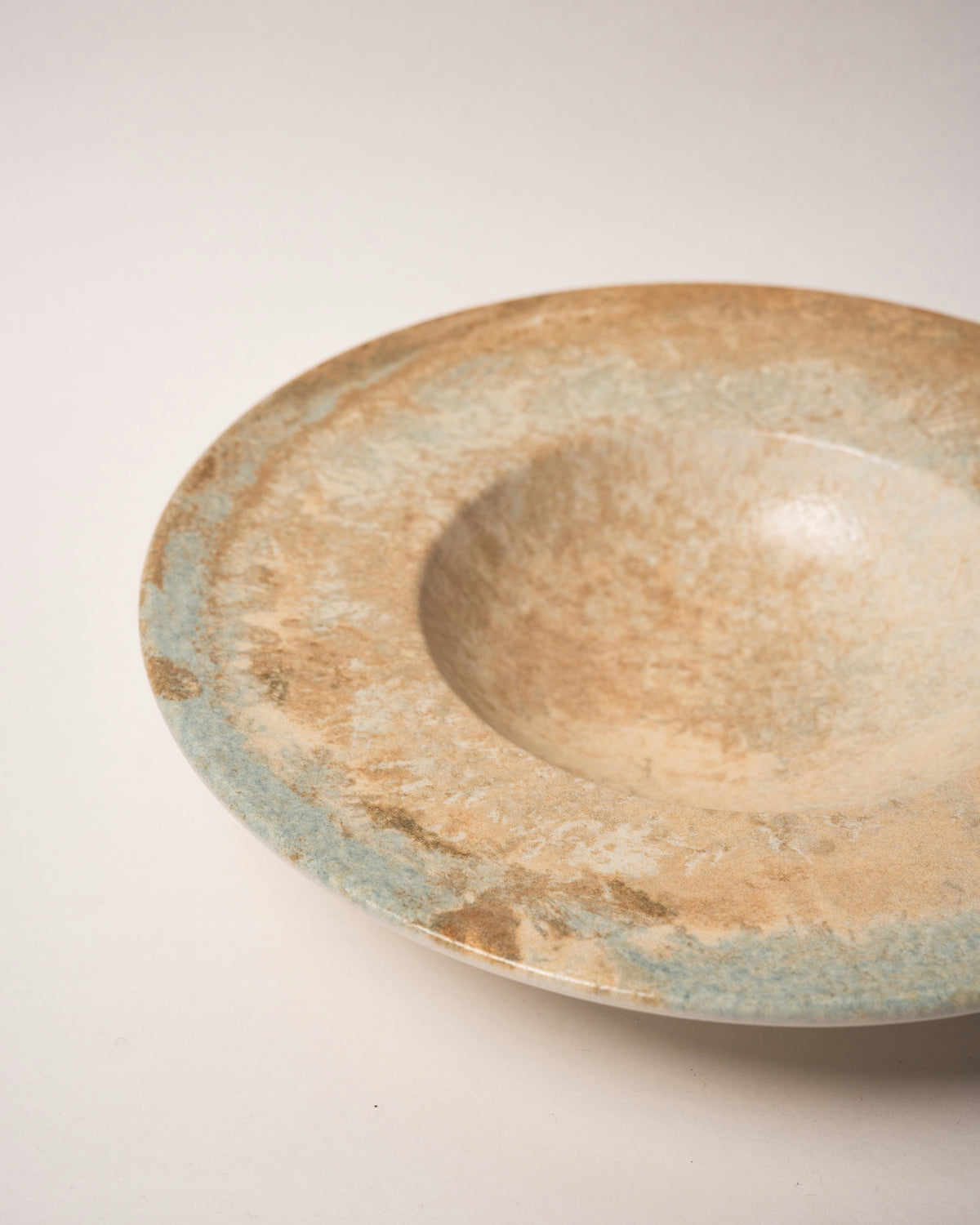 Side view of Aurelia porcelain banquet plate, bronze-toned finish