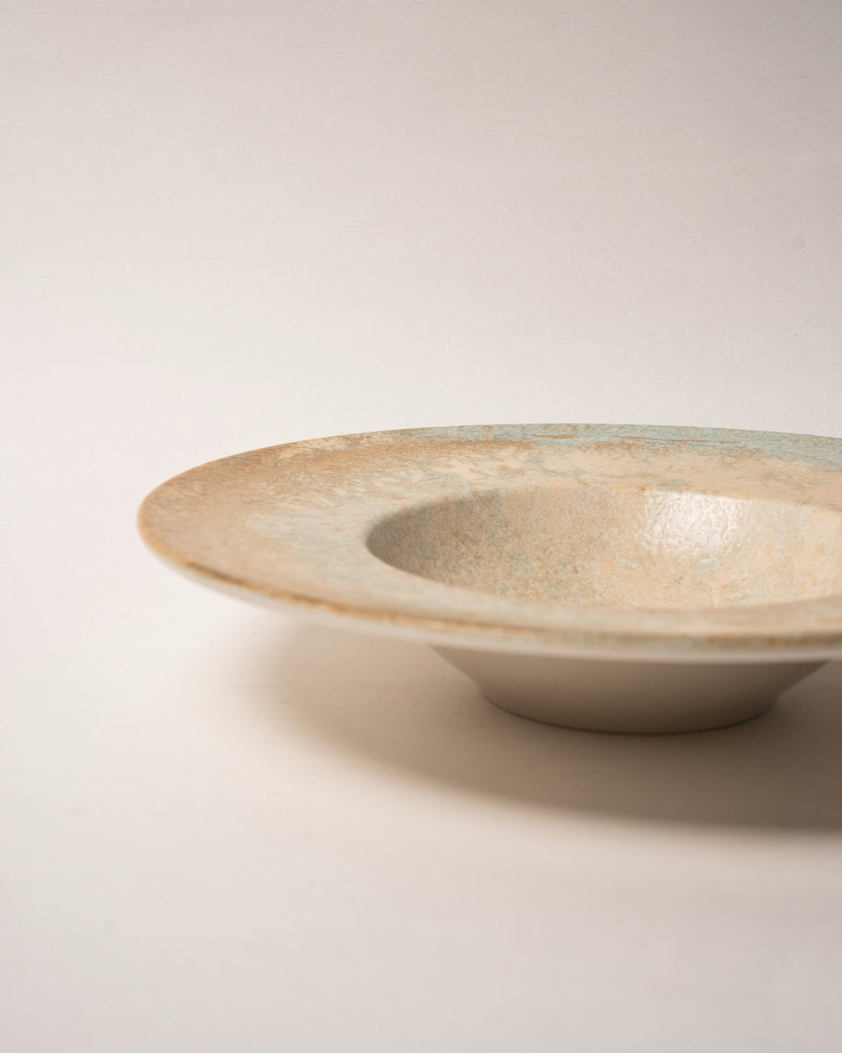 Tilted view of Aurelia porcelain banquet plate, angled to show depth