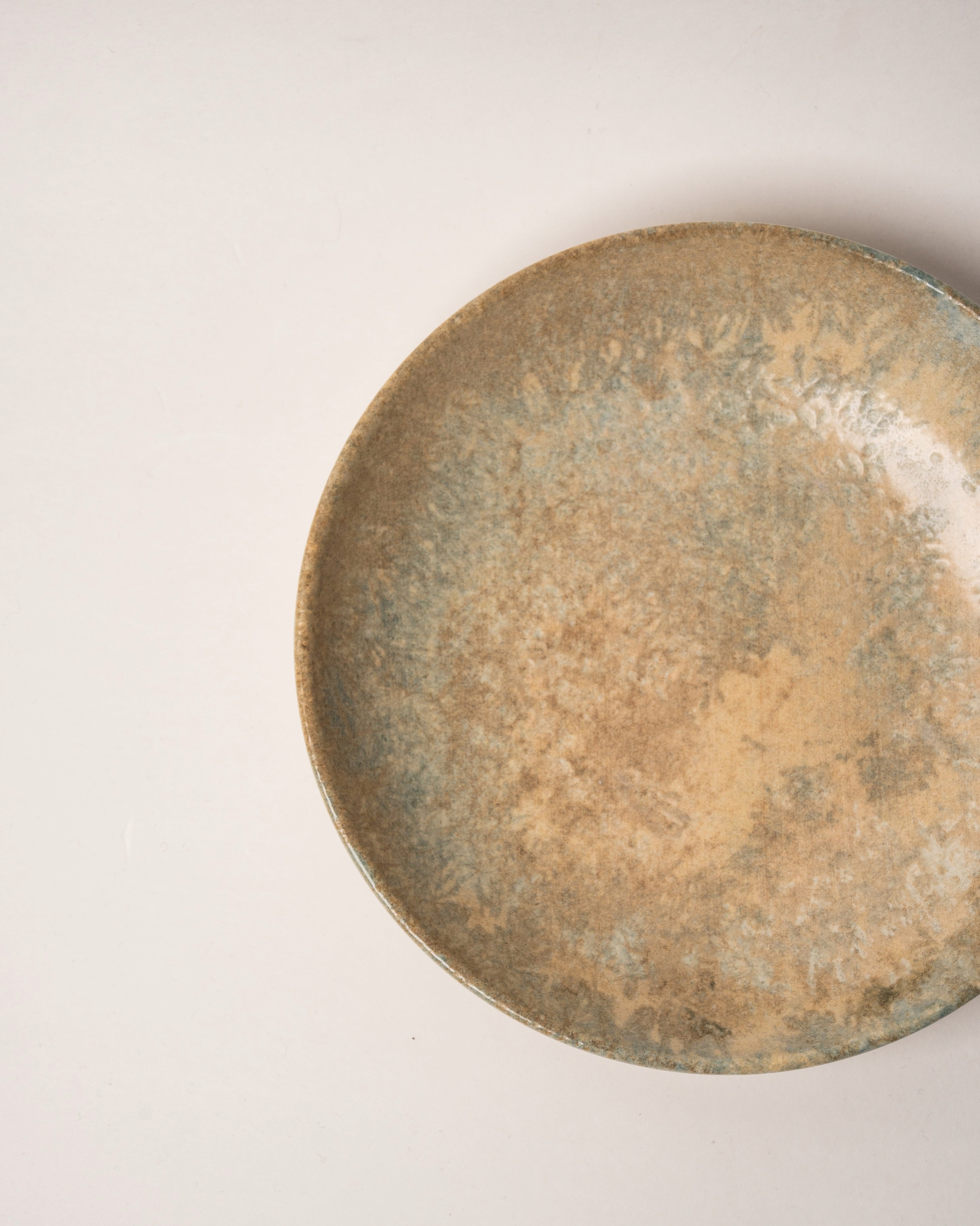 Angled view of Aurelia porcelain bistro bowl showing bronze glaze detail