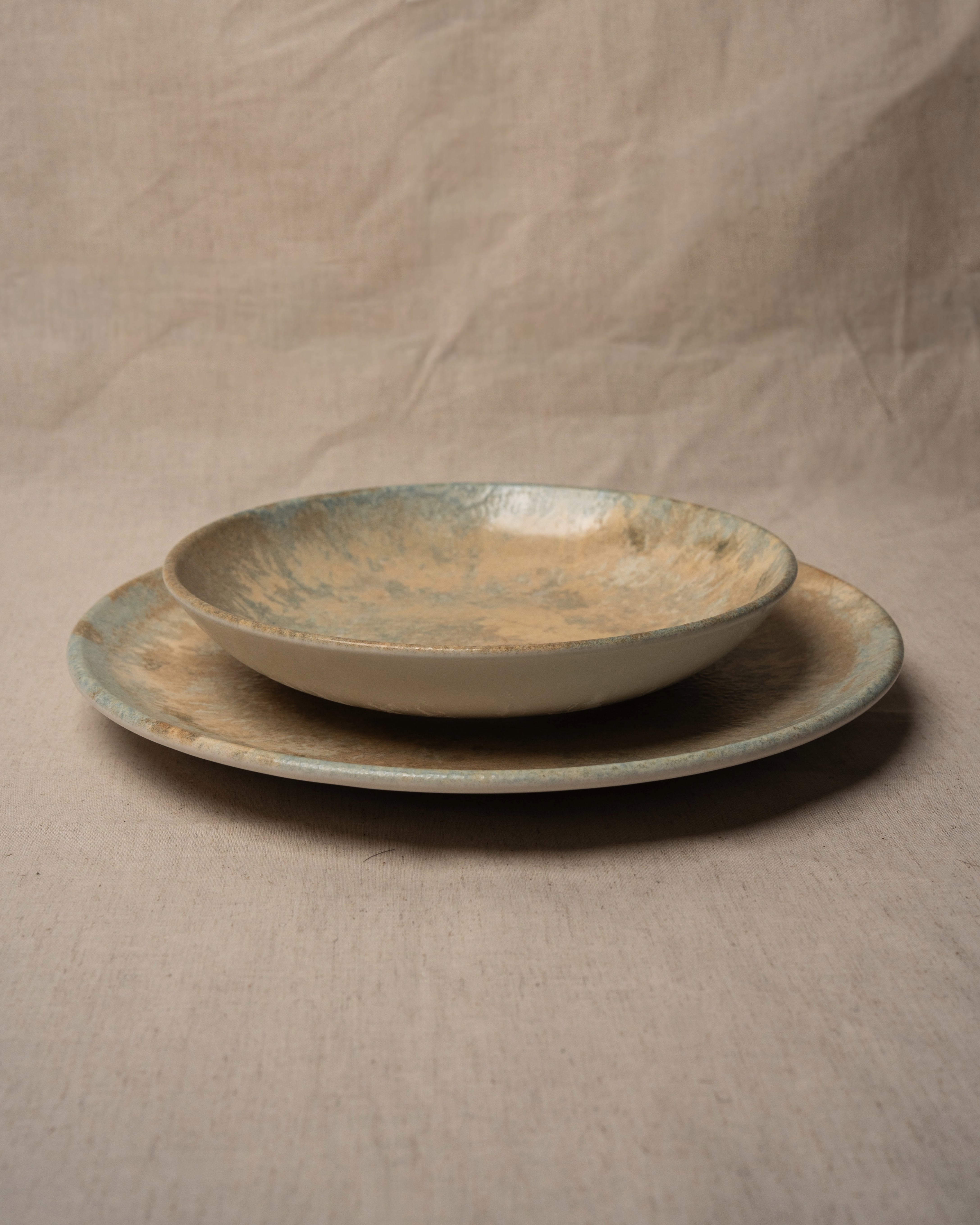 Aurelia porcelain plates stacked, bronze glaze detail