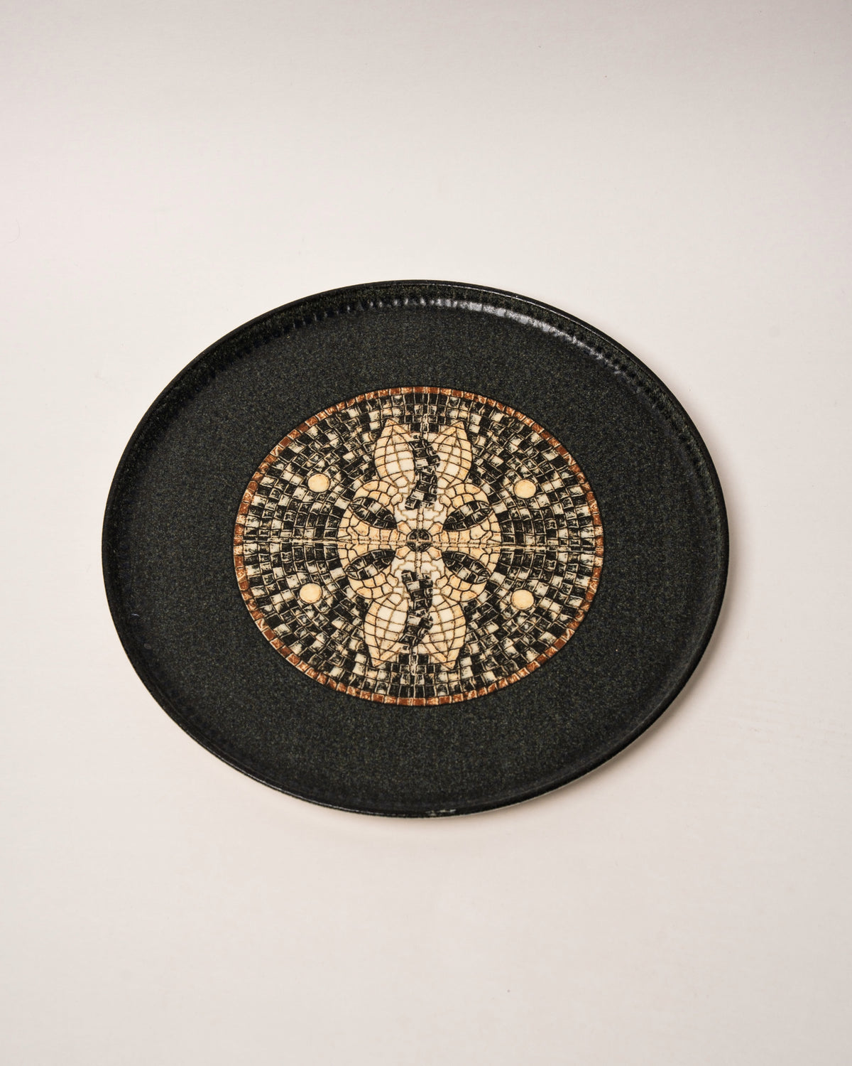 Close overhead view of Bee Mosaïque Black porcelain dinner plate, gold detail