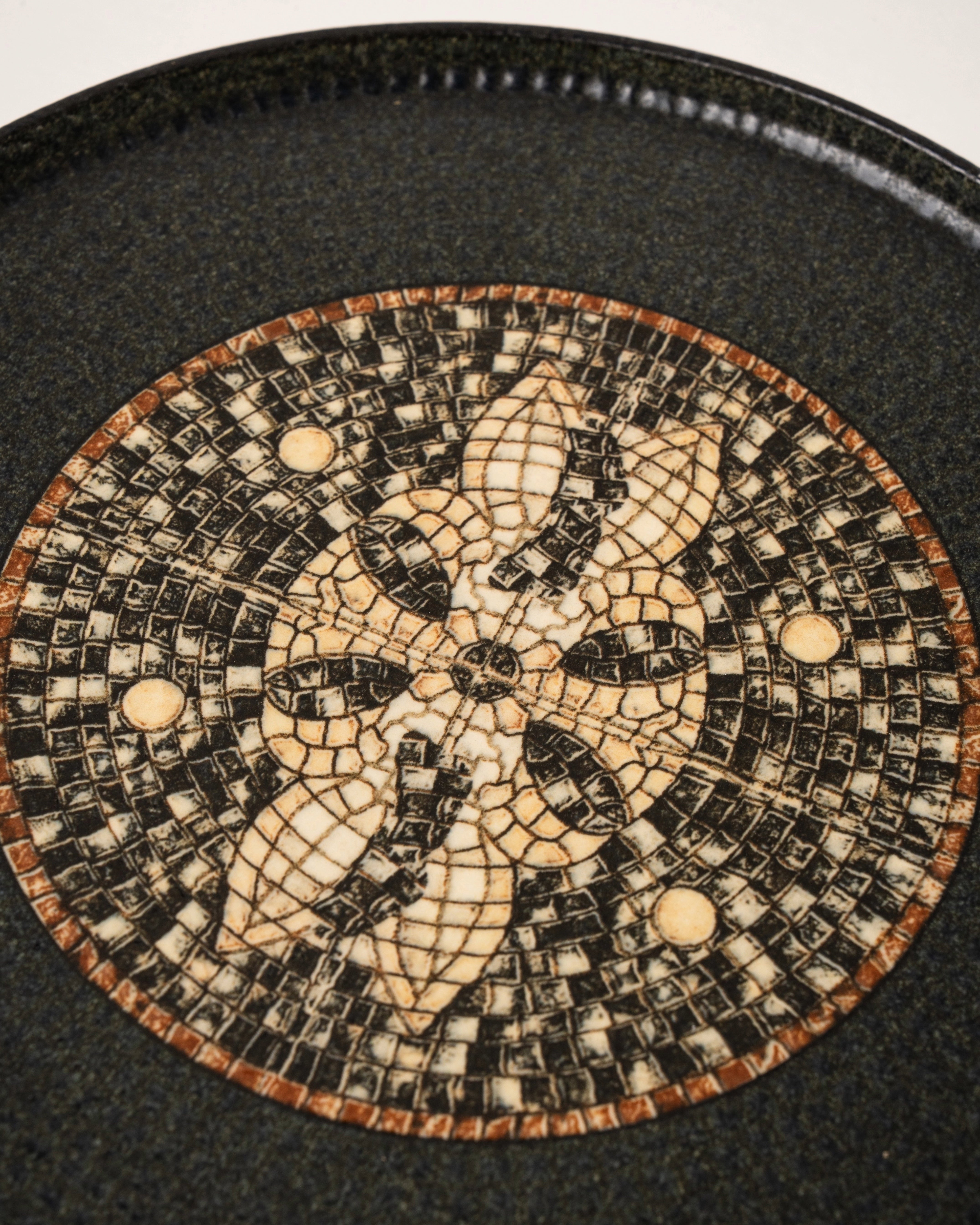 Overhead view of Bee Mosaïque Black porcelain dinner plate showing mosaic detail