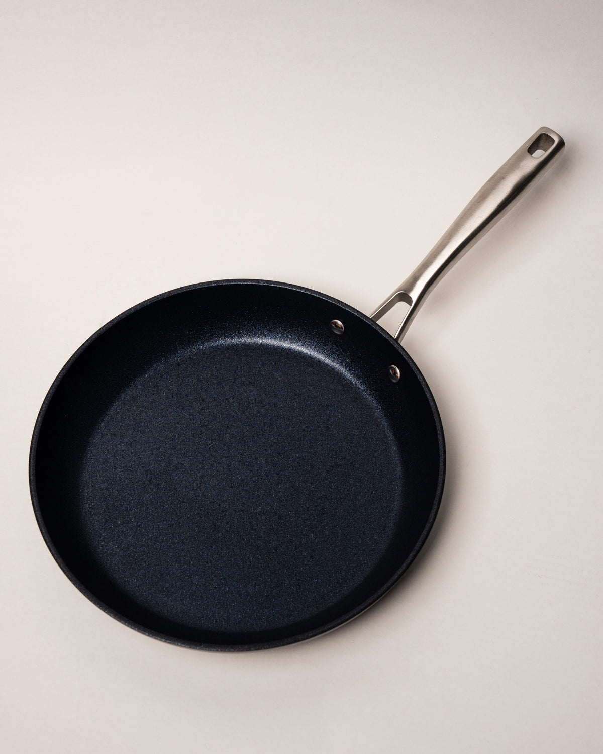 Close-up overhead view of BioDiamond diamond-coated frying pan, black non-stick finish