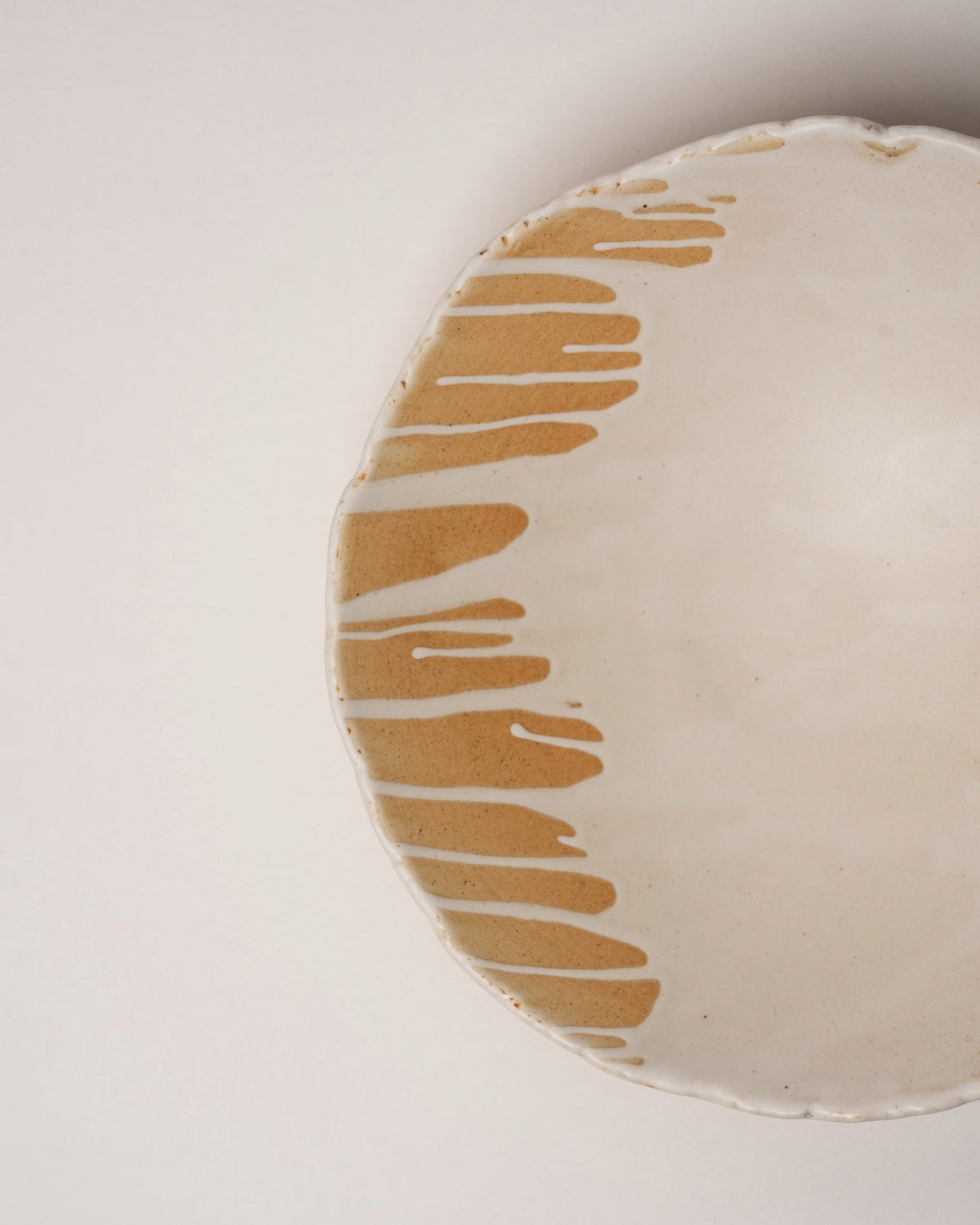 Angled view of Caramel porcelain bistro bowl, caramel glaze detail