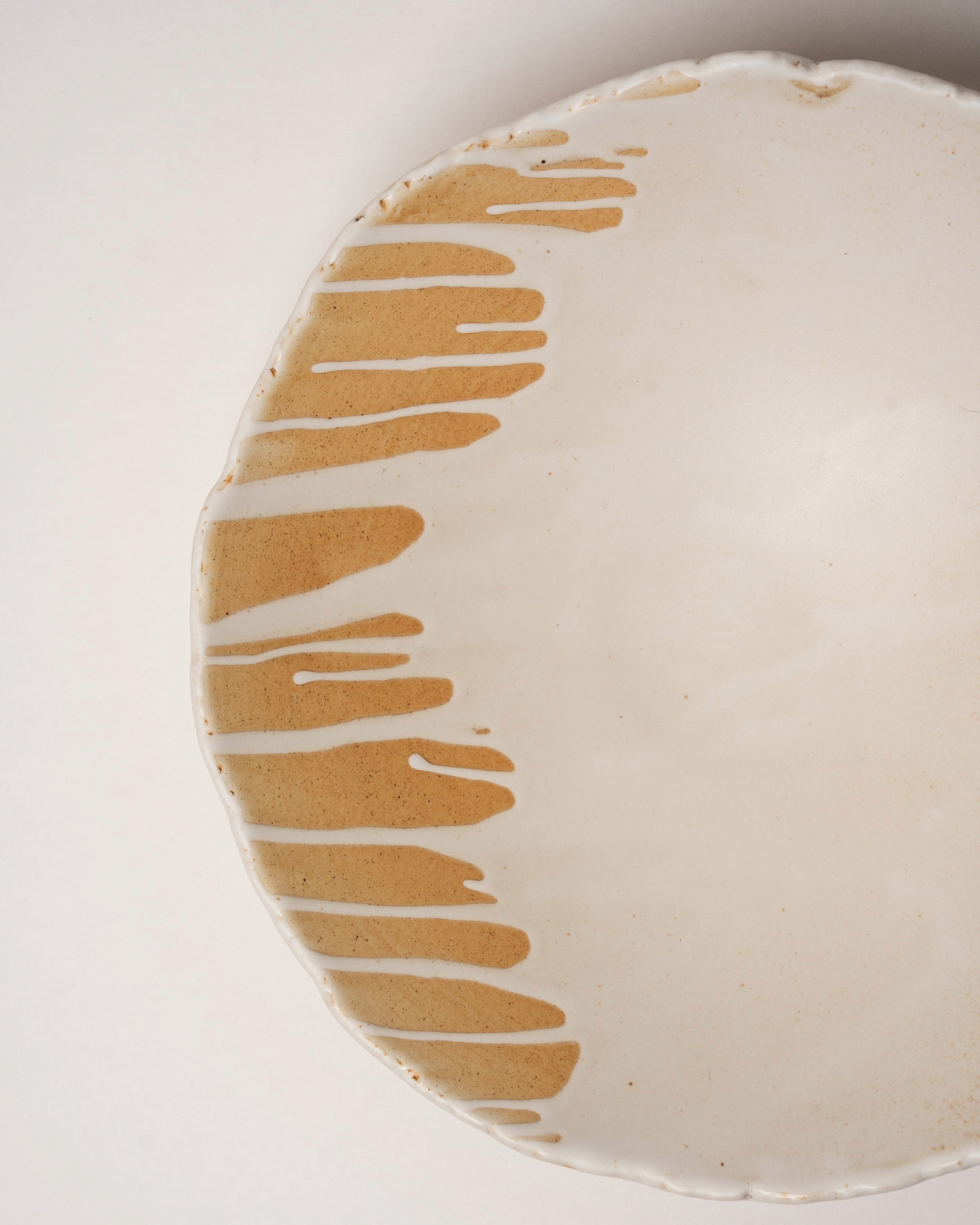 Overhead view of Caramel porcelain bistro bowl showing drizzle pattern