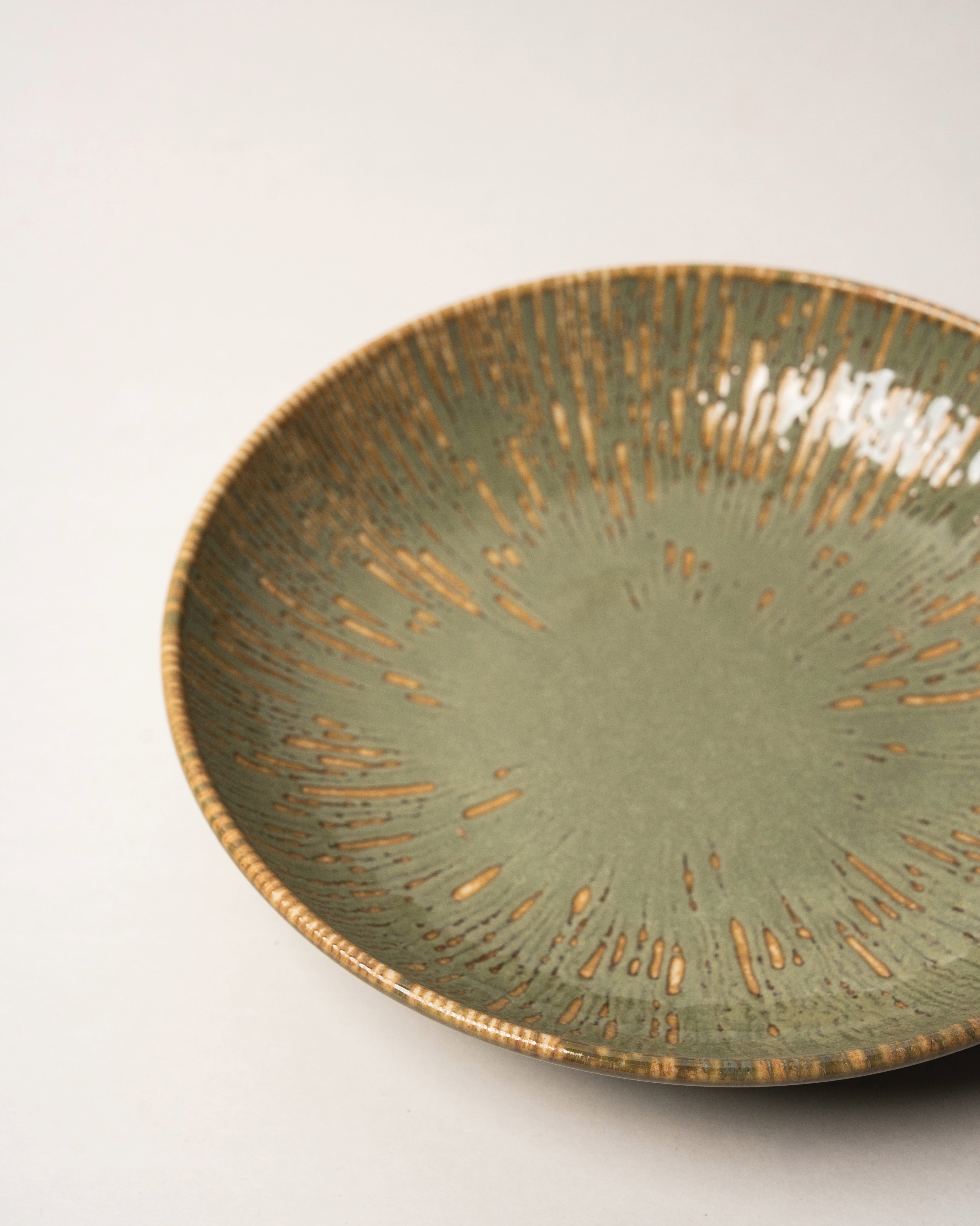 Overhead view of Colosseum Verdant porcelain bistro bowl showing gold rim detail