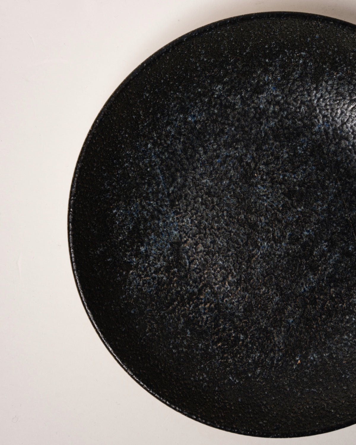 Angled view of Cosmos porcelain bistro bowl, black finish