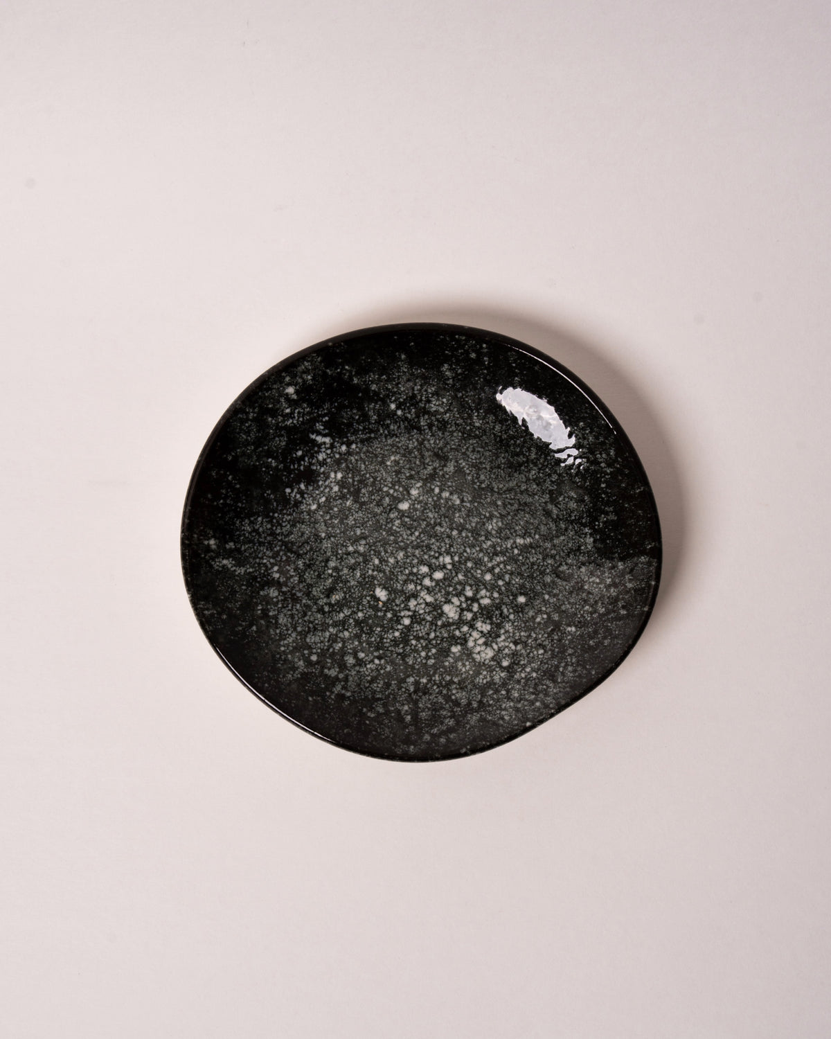 Close-up of Cosmos porcelain small plate grey speckled glaze texture