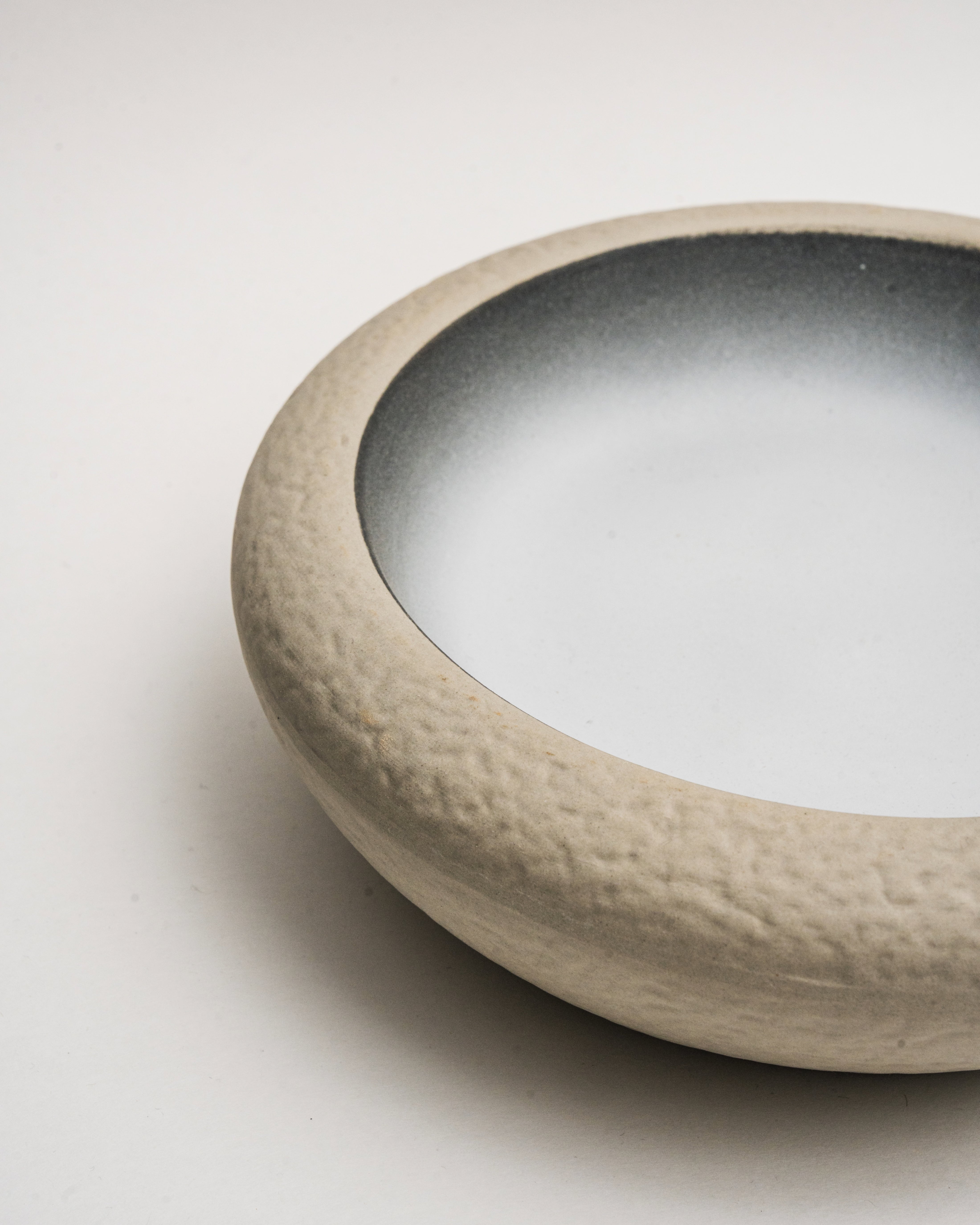 Overhead view of Crater porcelain bistro bowl showing two-tone glaze