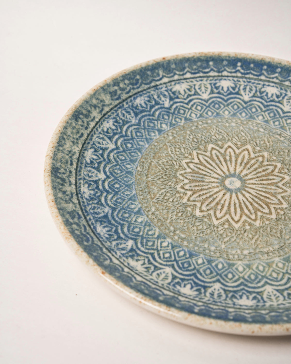 Close-up of Embroideries of Atlantis porcelain plate, blue and gold pattern texture