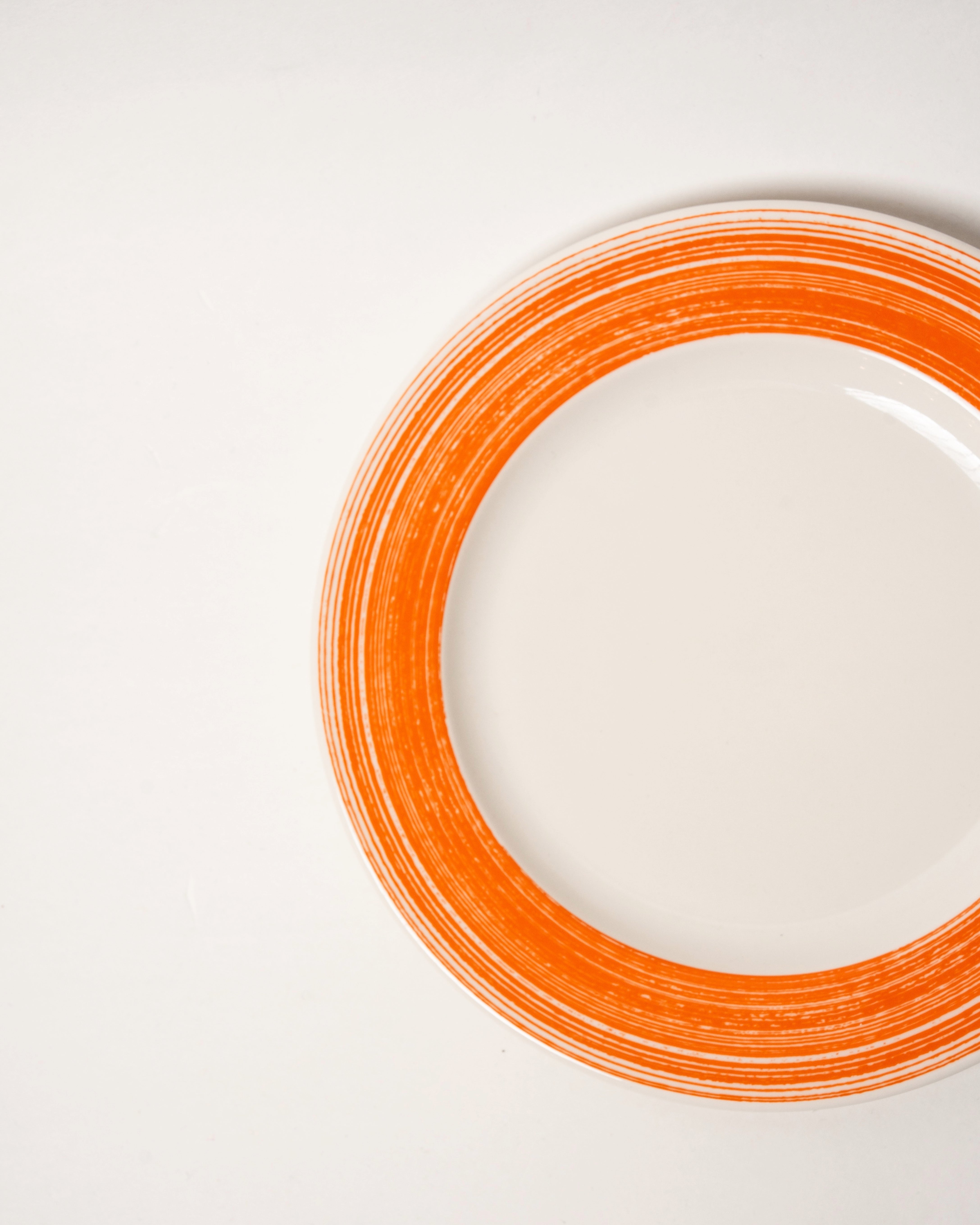 Overhead view of Fresh Orange porcelain dinner plate showing orange rim