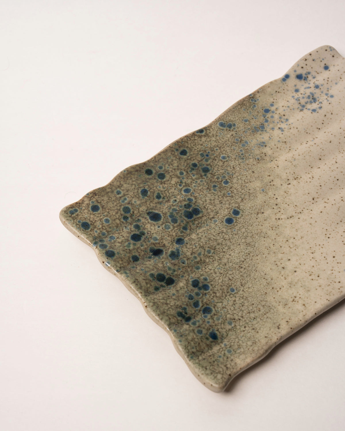 Tilted view of Gaia porcelain rectangular plate, angled to show depth
