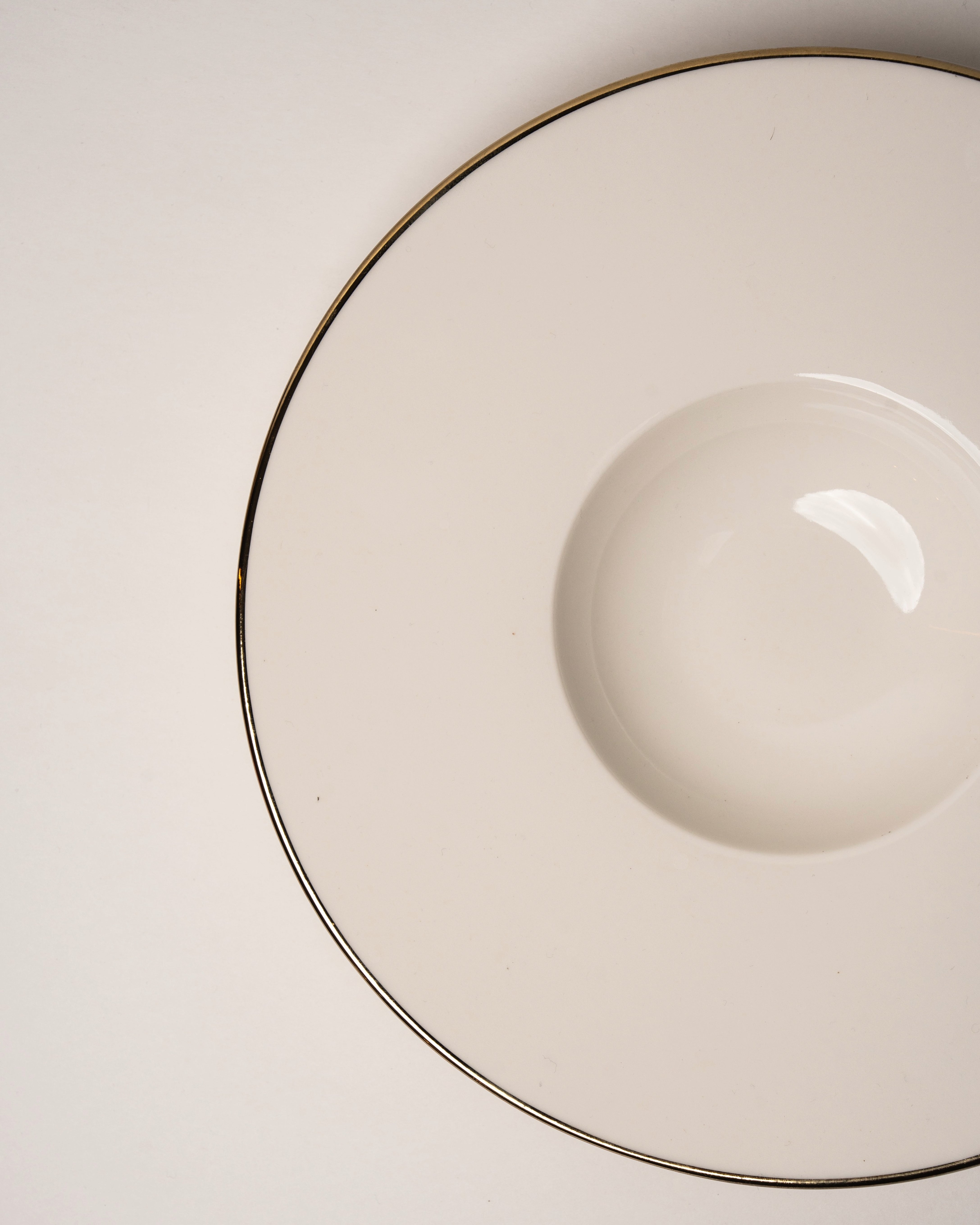 Angled view of Her Highness porcelain banquet plate showing gold rim detail