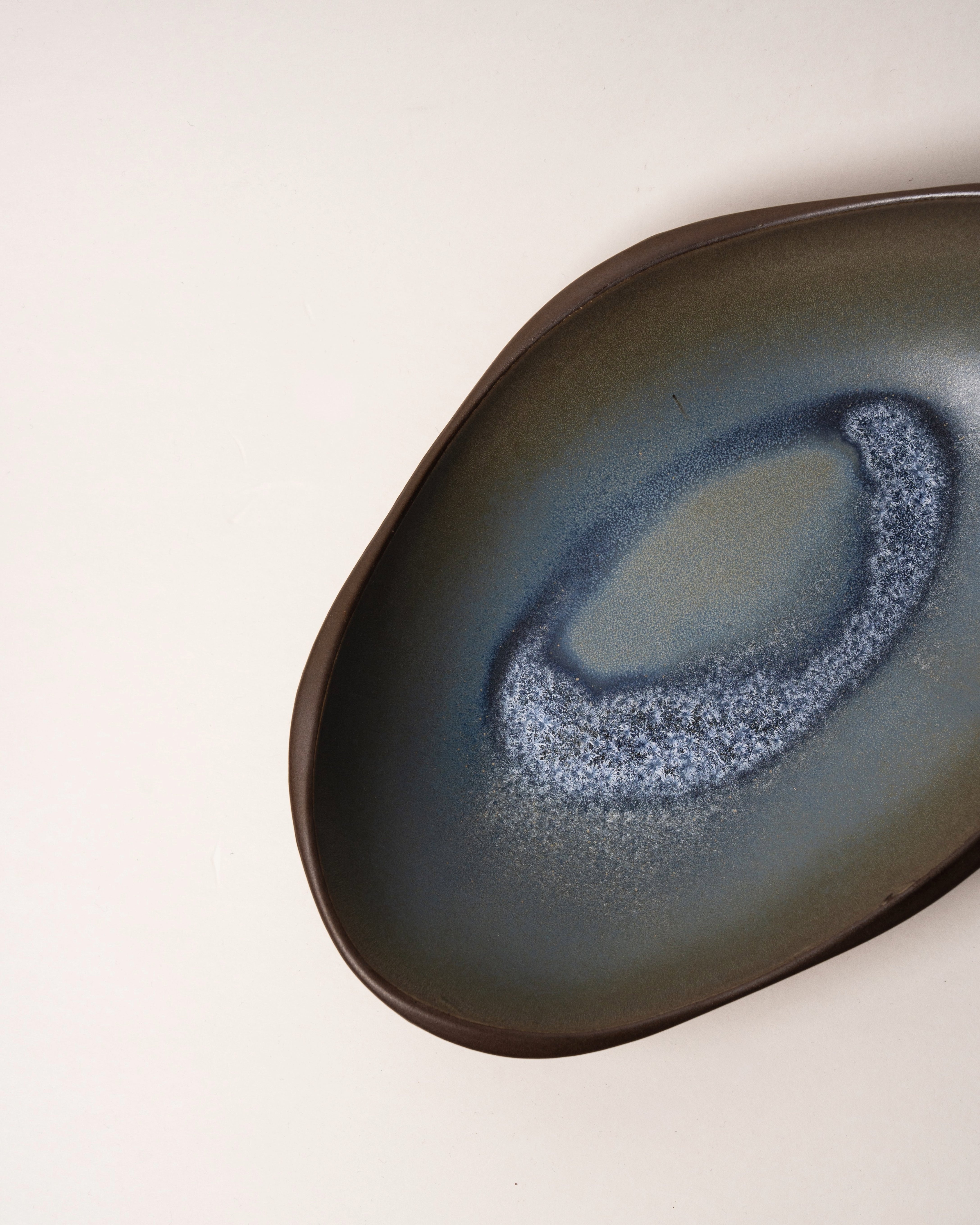 Angled view of Lagoon porcelain bistro bowl showing blue glaze pooling