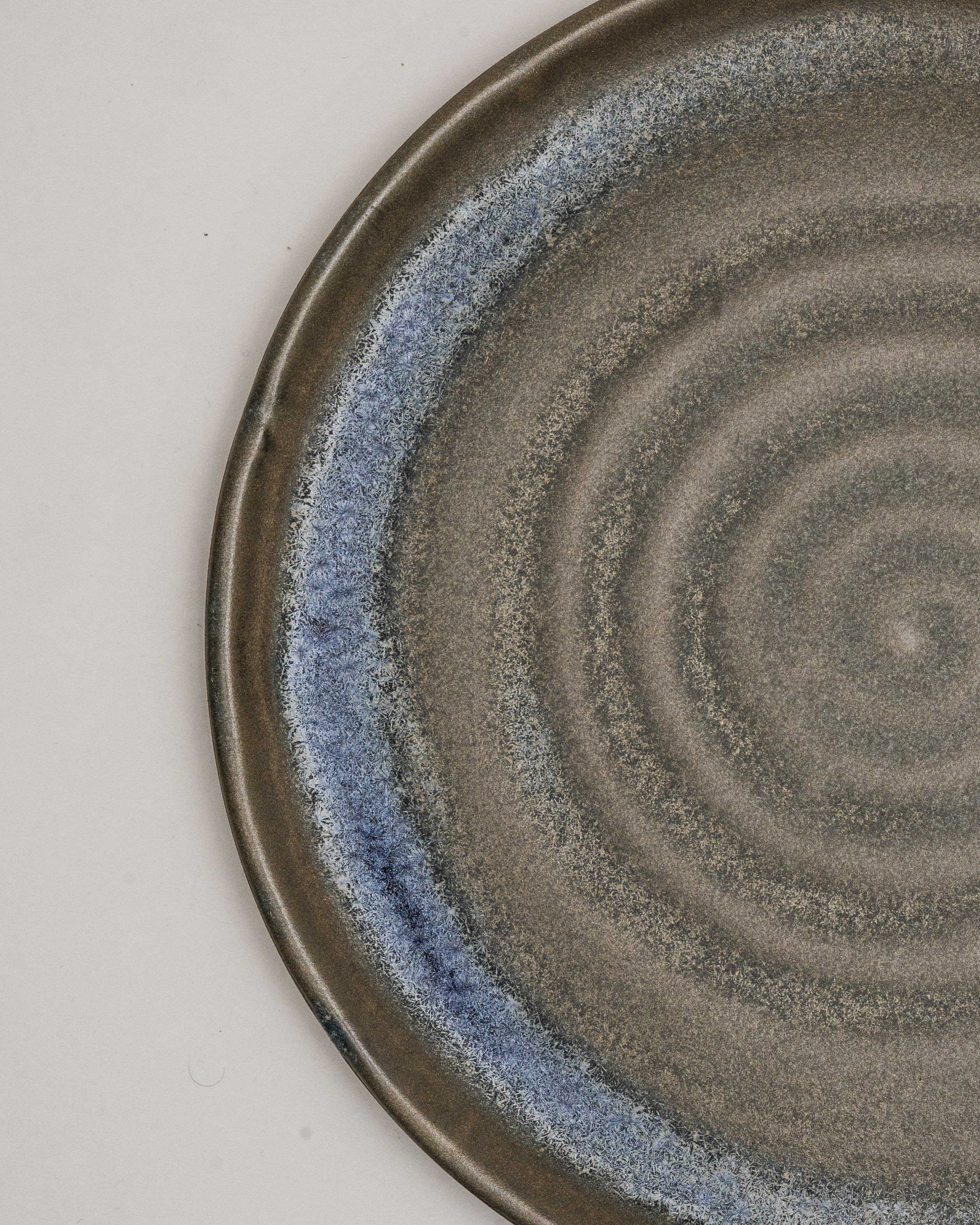 Overhead view of Lagoon porcelain dinner plate showing blue rim accent