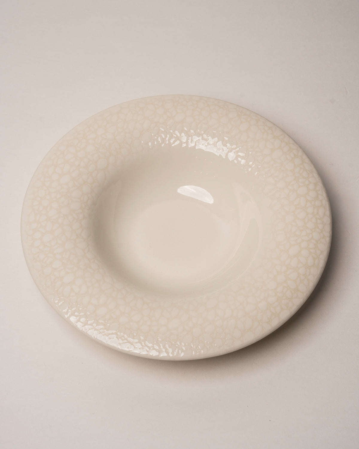 Side profile of Marlena porcelain bistro plate, textured surface visible