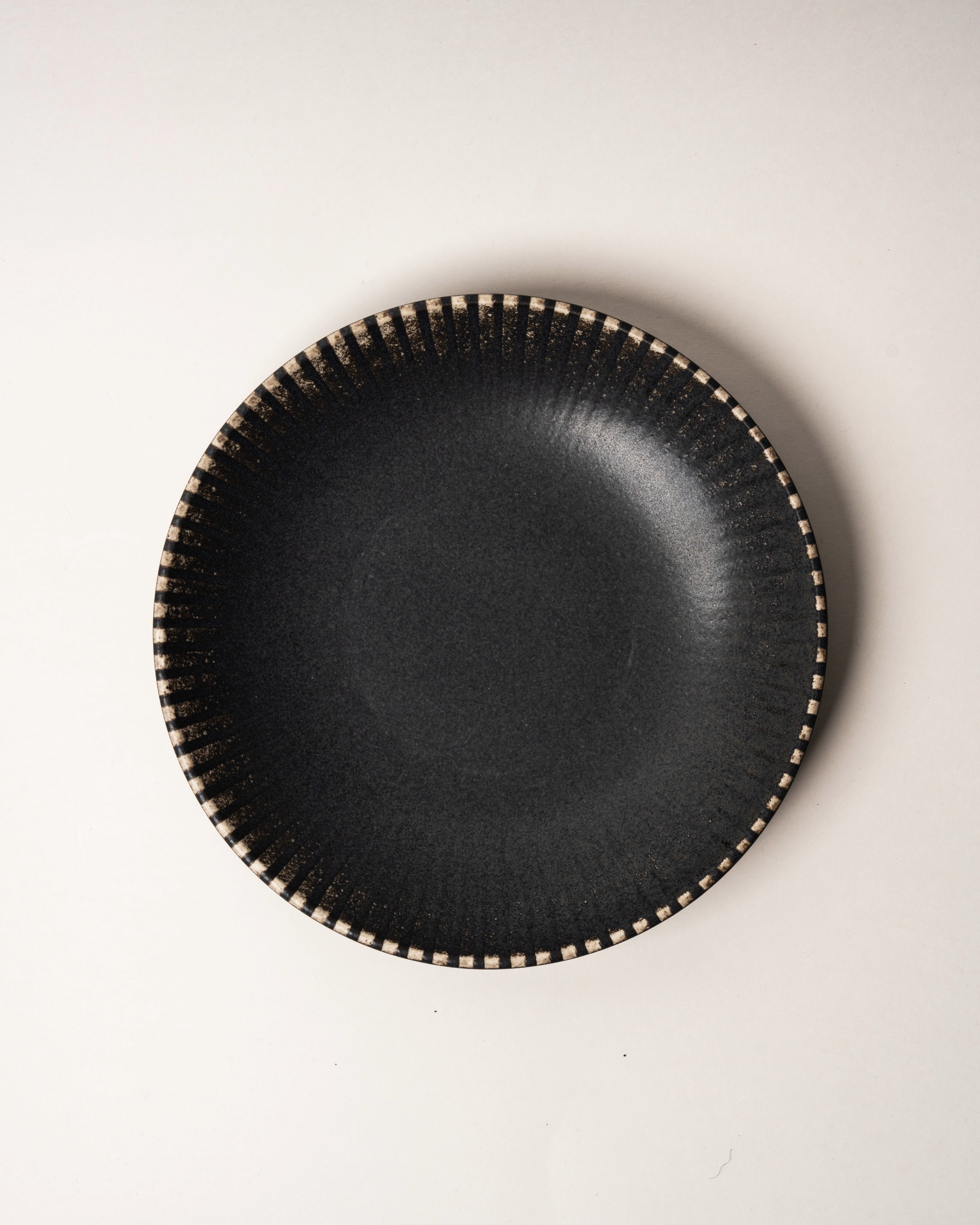 Close overhead view of Obsidian porcelain bowl showing beaded rim detail