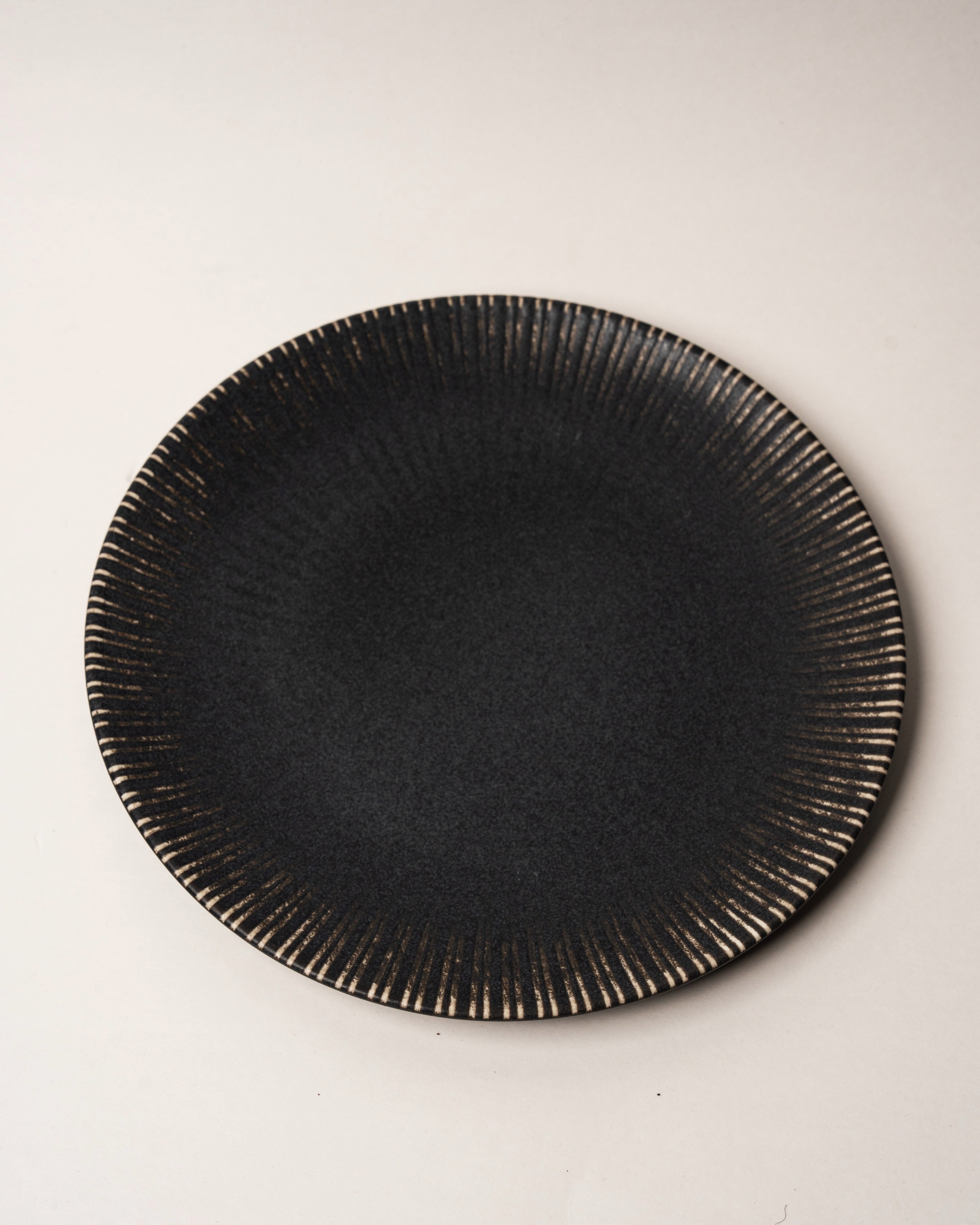 Obsidian porcelain dinner plate, matte black glaze with beaded rim, 11.2 inch