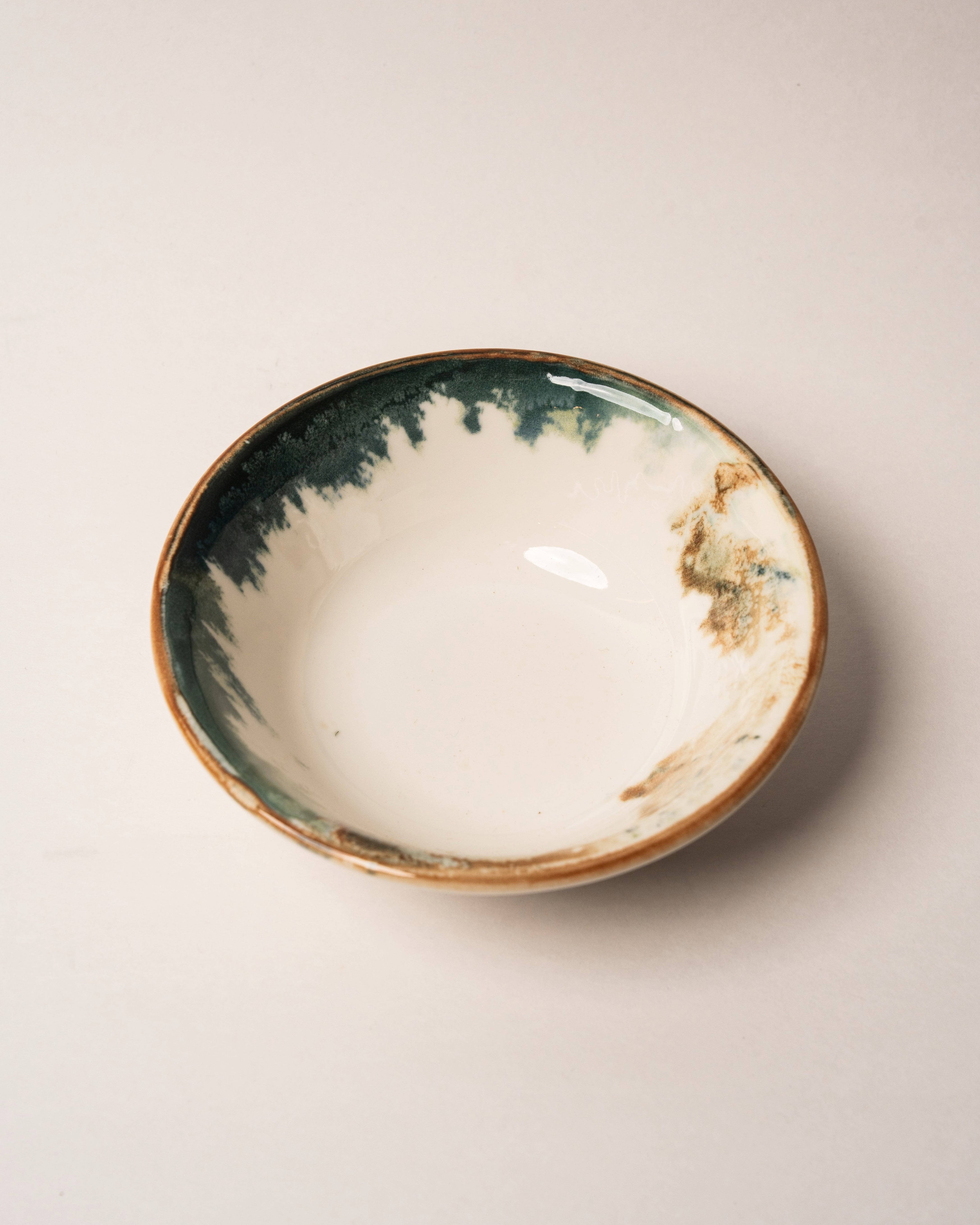Overhead view of Pelagos porcelain bowl showing teal and gold rim