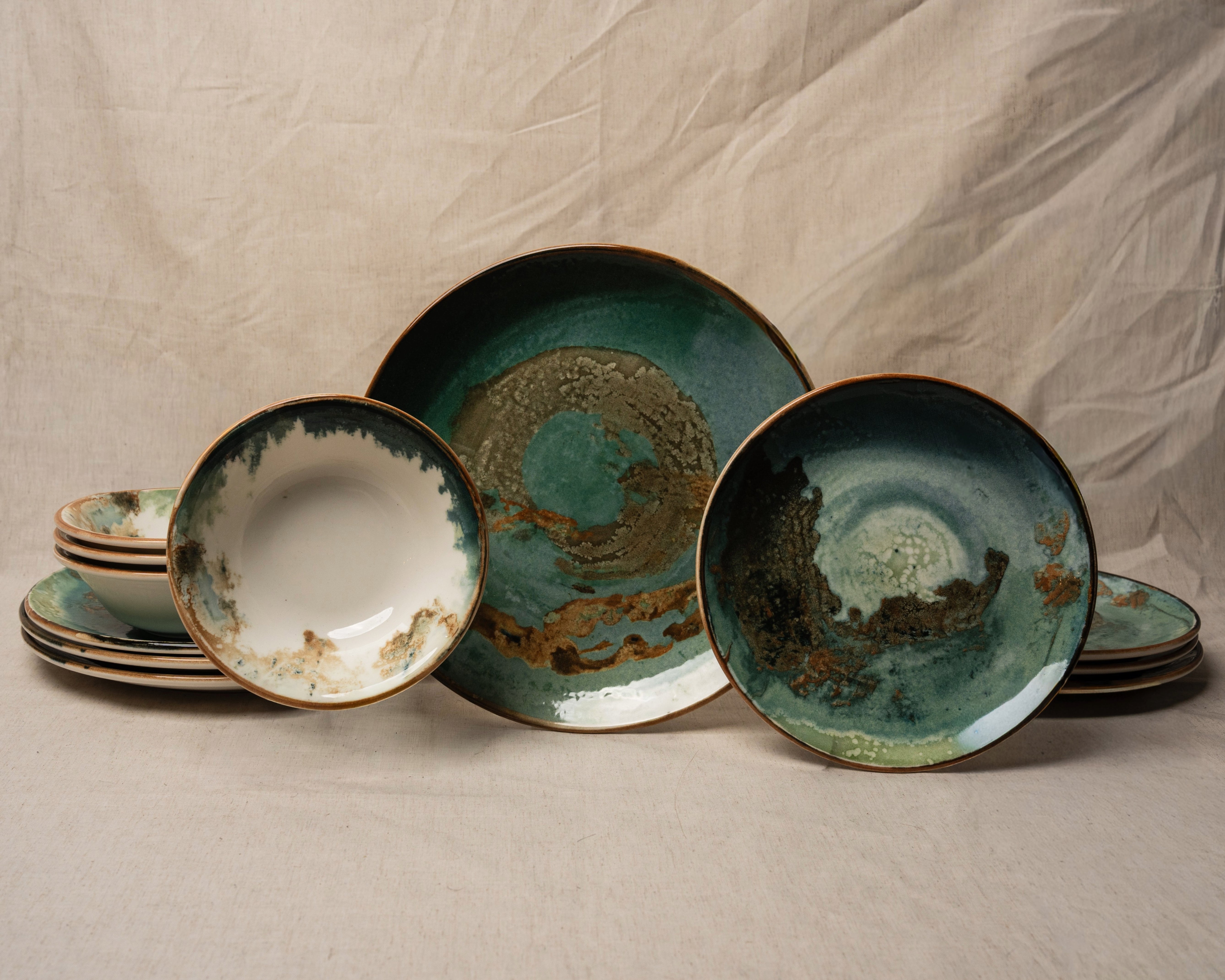 Pelagos porcelain dinnerware set, teal and gold glaze, full 12-piece collection