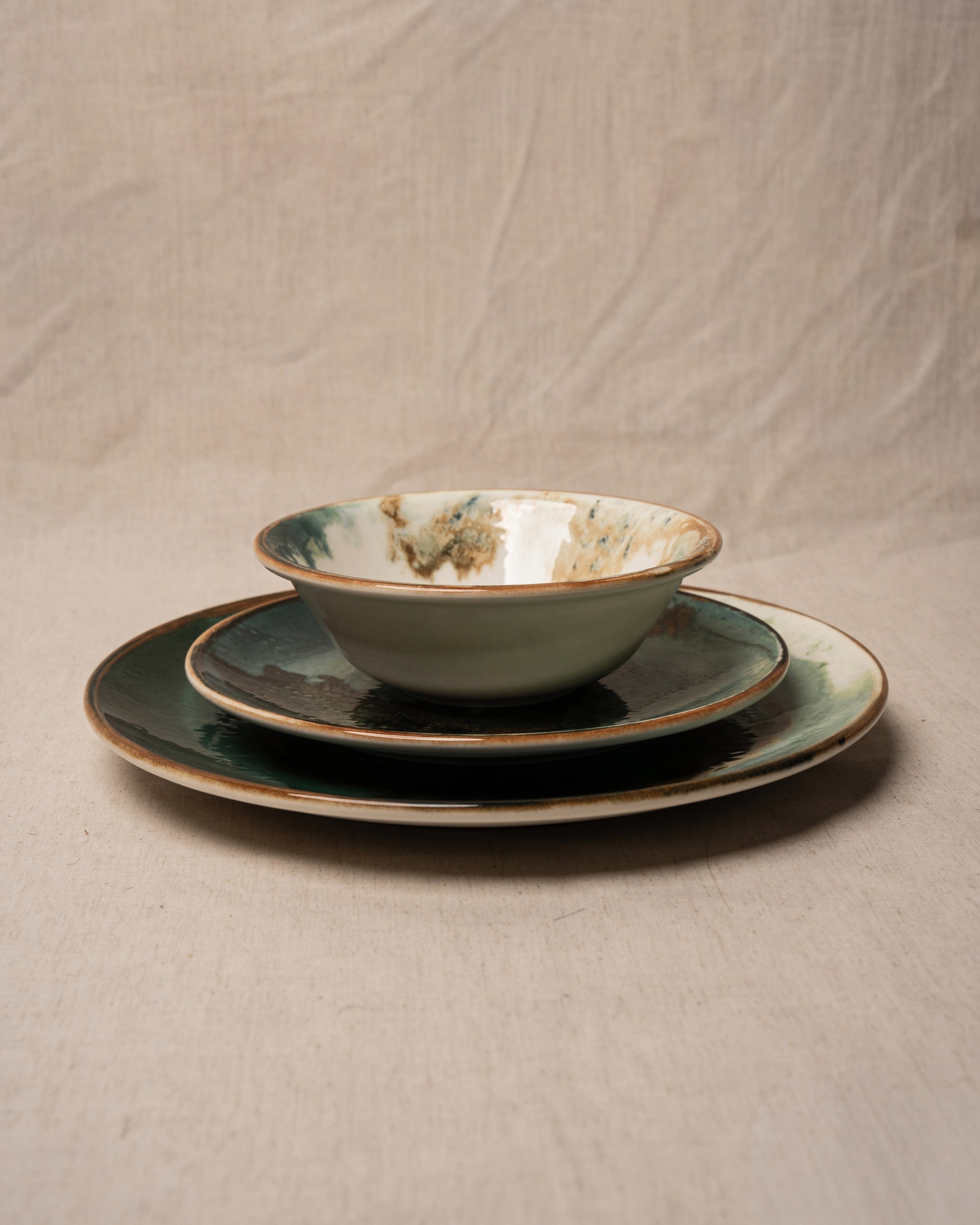 Angled view of Pelagos porcelain plate, teal glaze pattern
