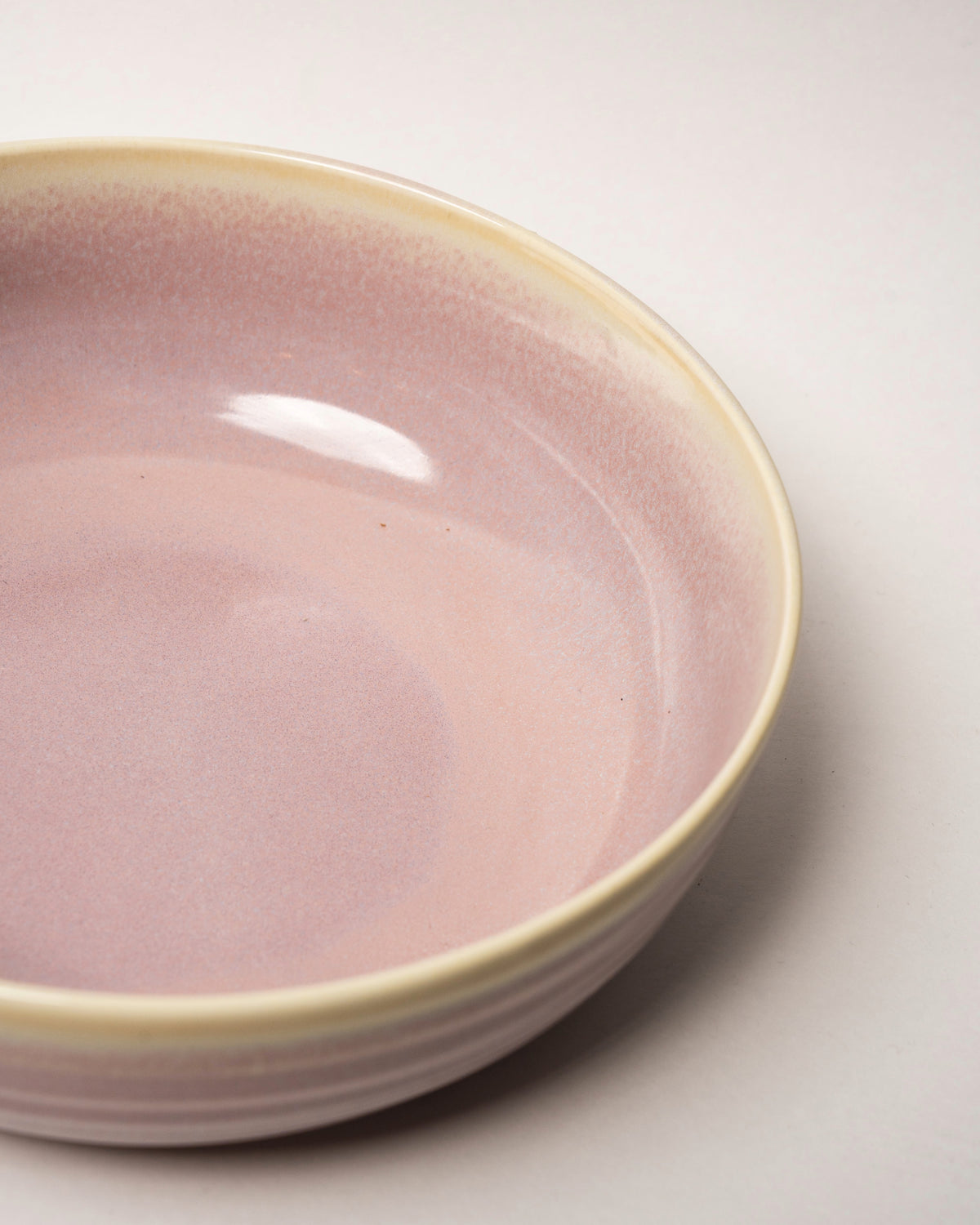 Angled view of Pink Pott porcelain fruit bowl, blush pink finish
