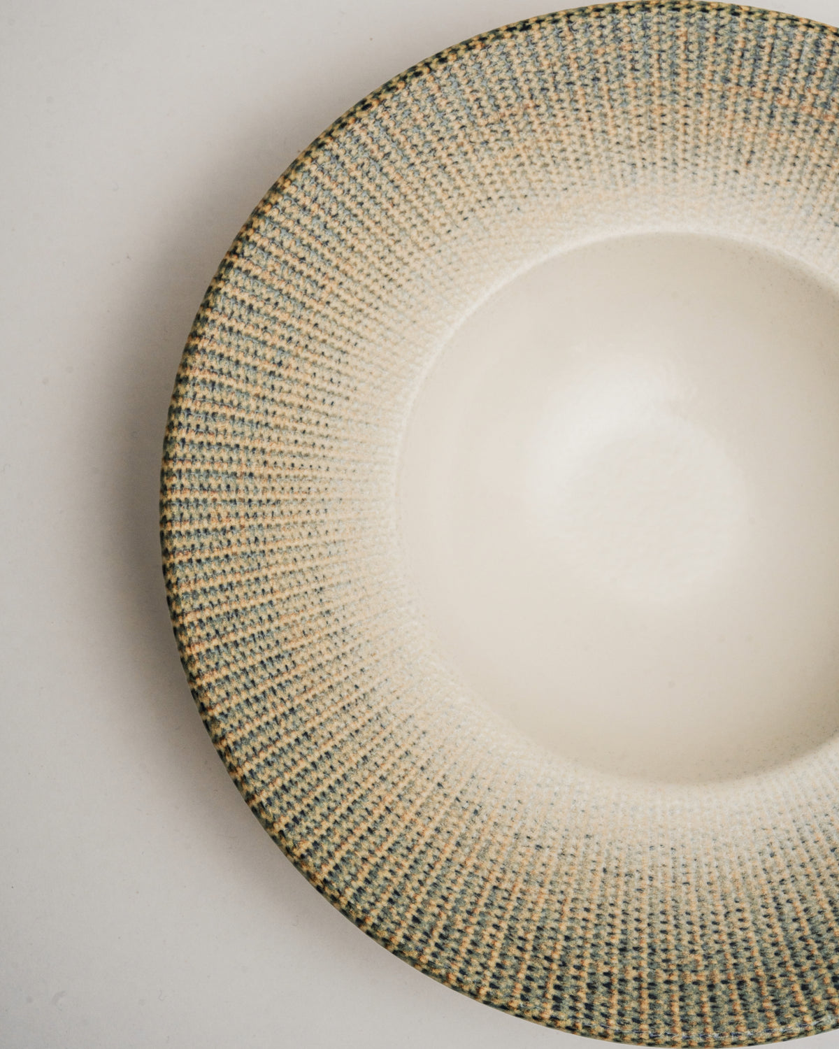 Close overhead view of Python porcelain banquet plate, glaze texture
