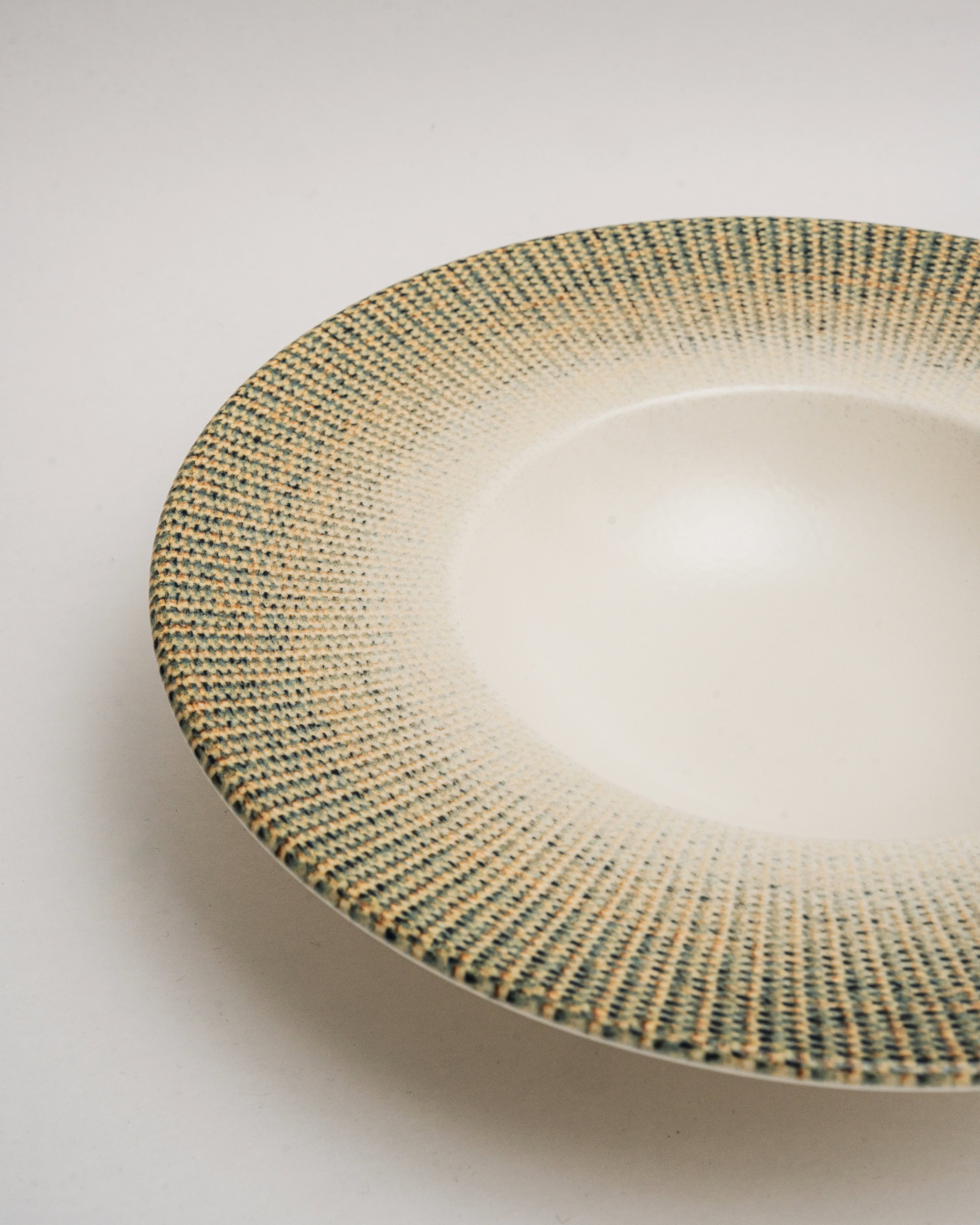 Overhead view of Python porcelain banquet plate showing textured rim detail