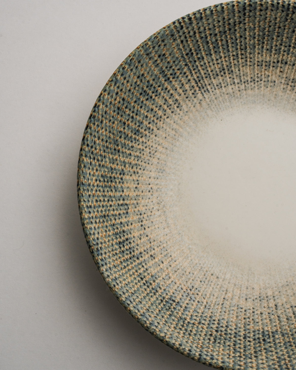 Angled view of Python porcelain bistro bowl, olive rim and cream center