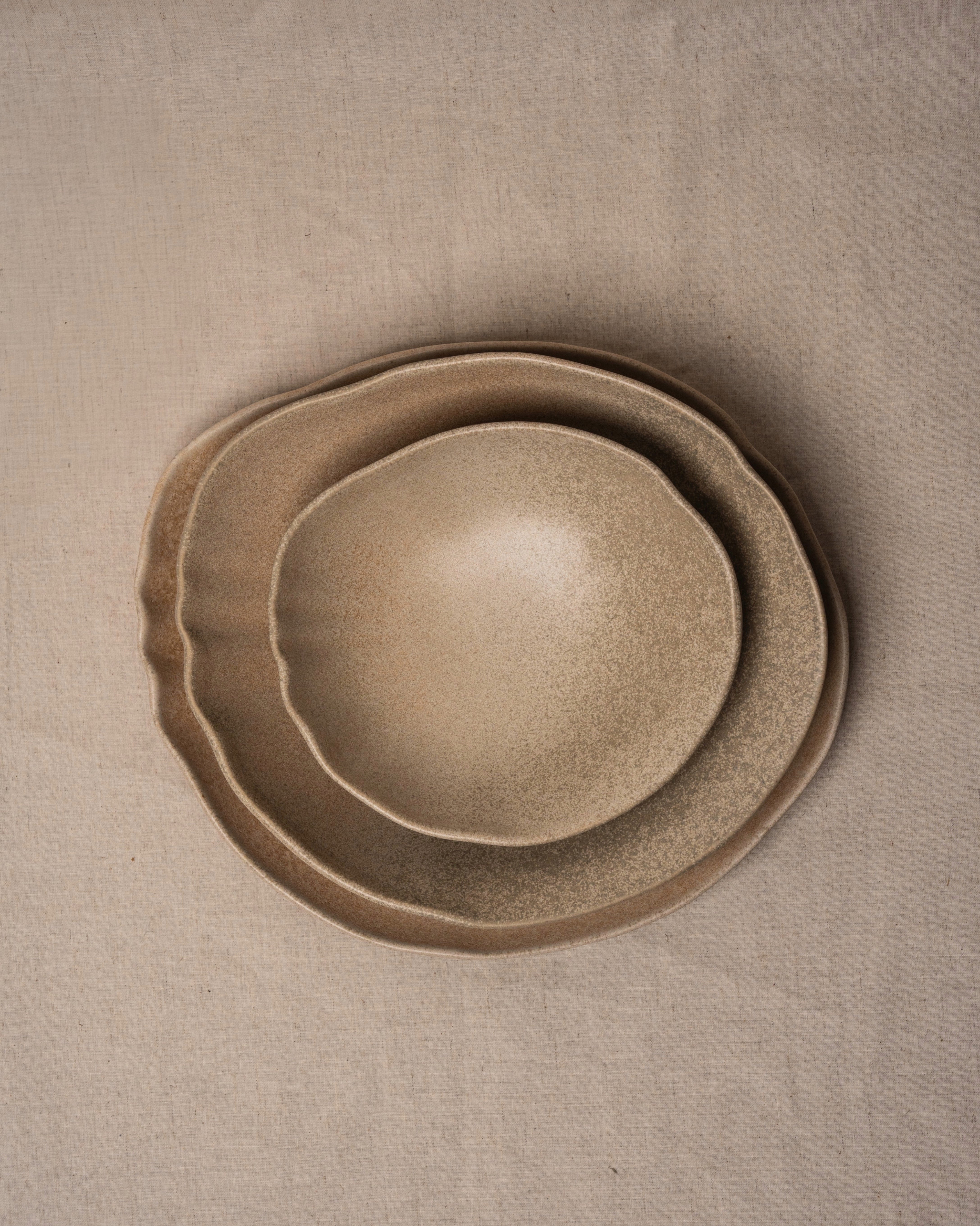 Overhead view of Sahara porcelain bowl, sand-toned glaze