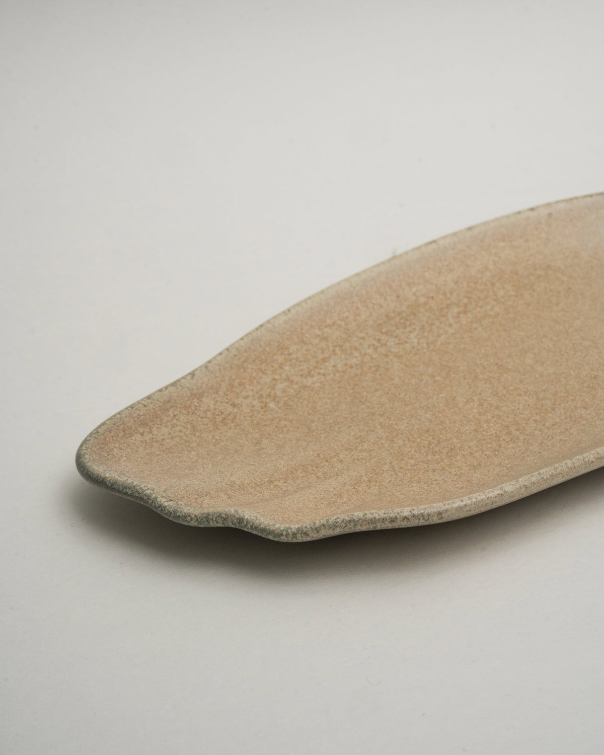 Side view of Sahara porcelain rectangular plate, organic shape