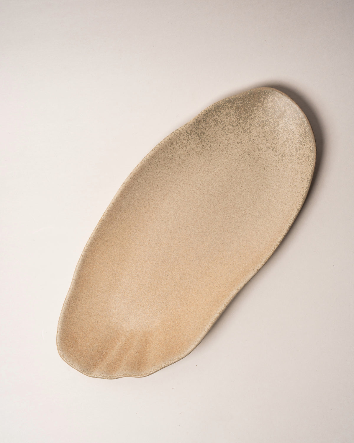 Side view of Sahara porcelain rectangular plate, organic shape