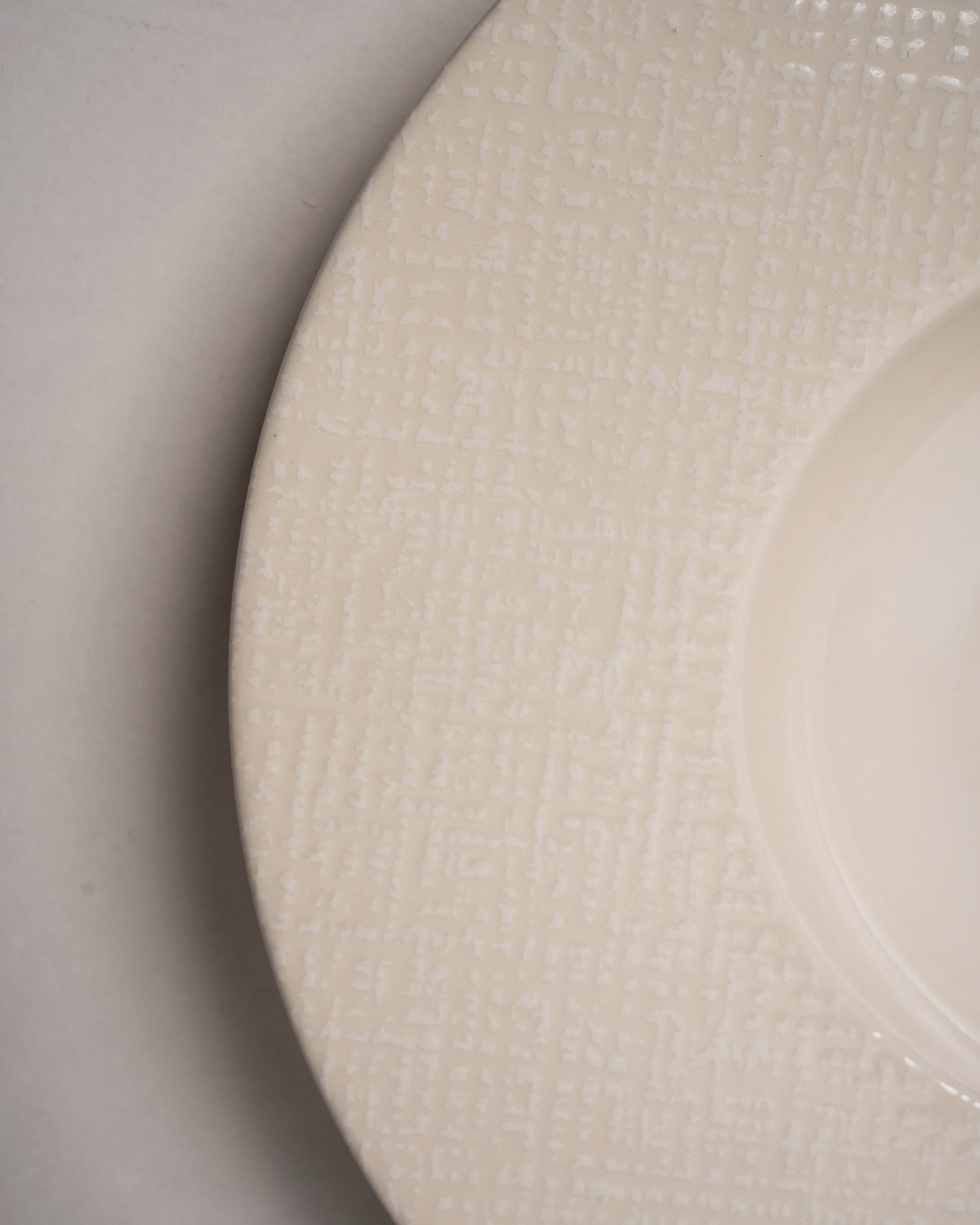 Close angled view of Serene porcelain banquet plate, matte texture