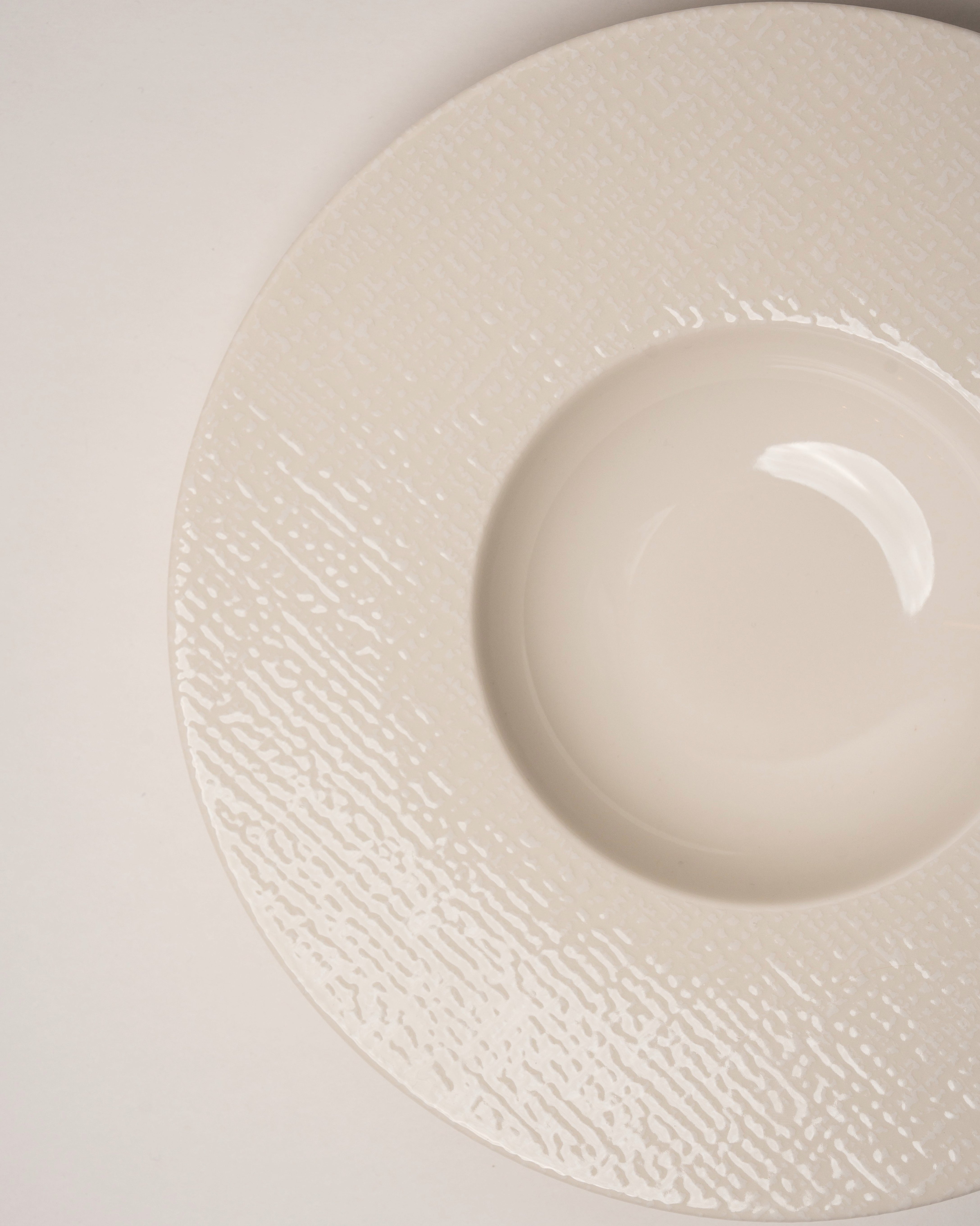 Overhead view of Serene porcelain banquet plate showing matte white glaze