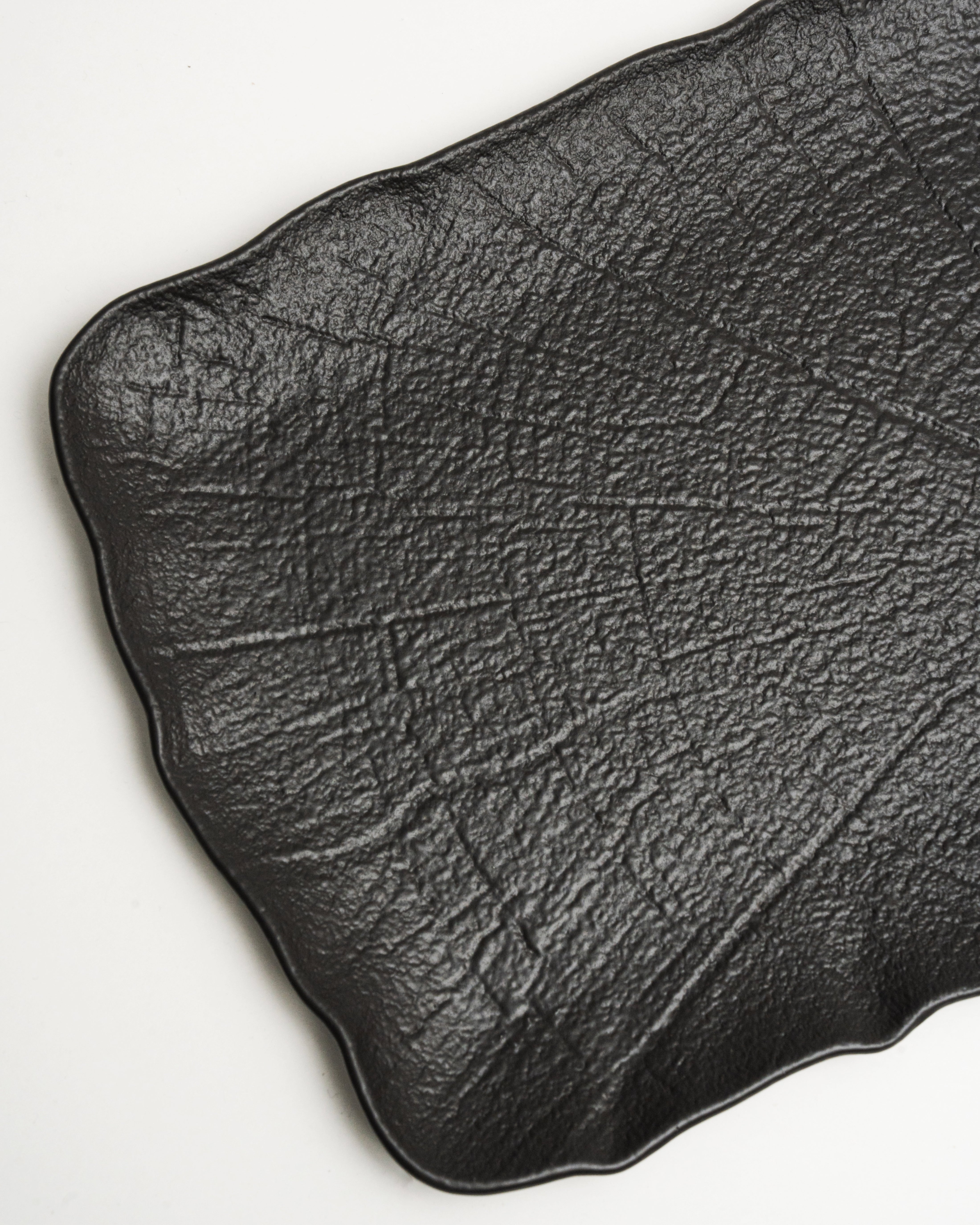 Angled view of Shade porcelain platter showing matte black finish