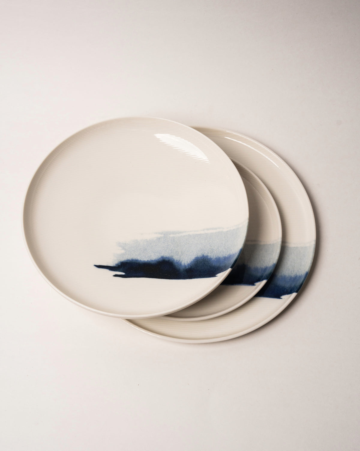The Wave porcelain bowls stacked, blue wave pattern visible