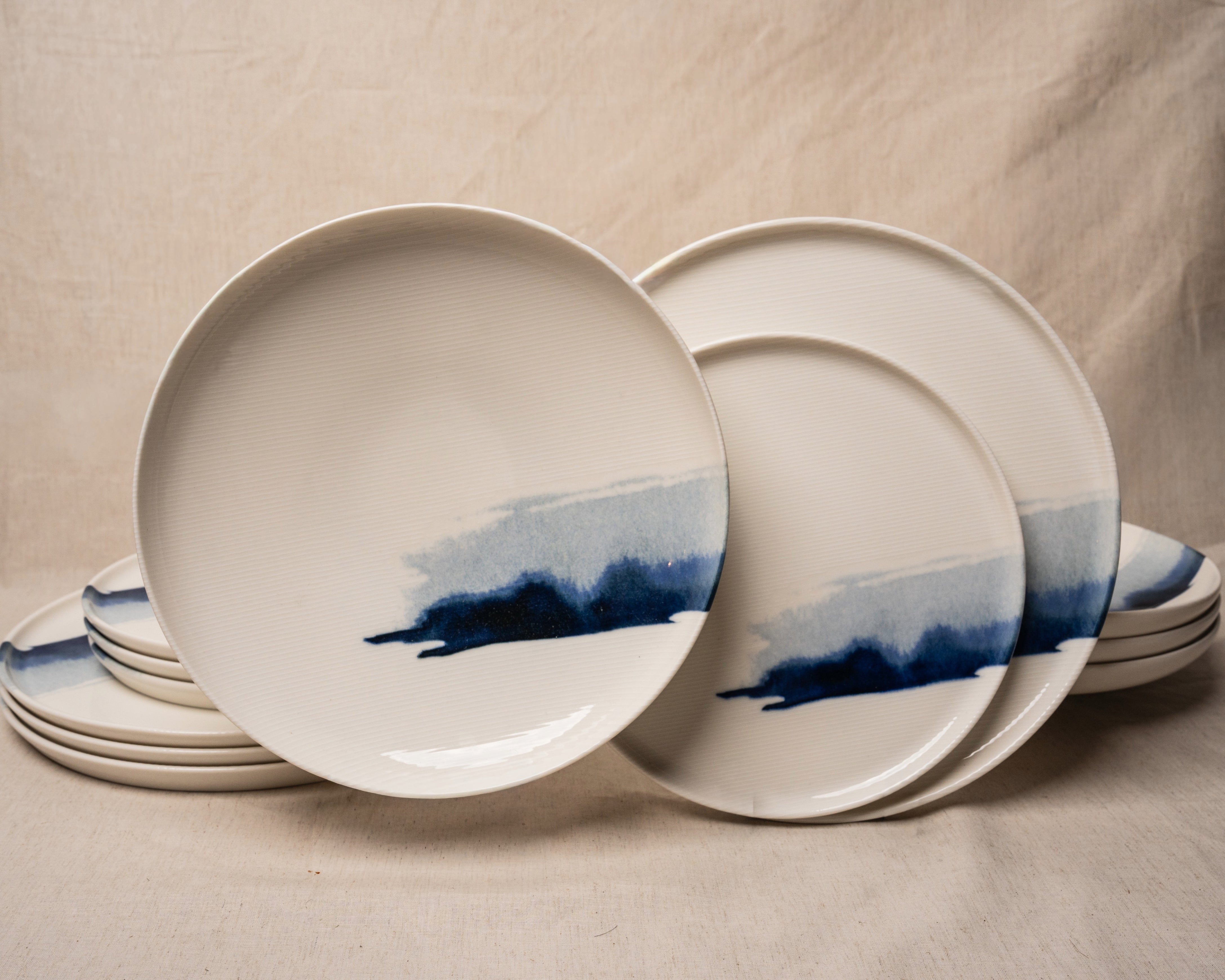 The Wave porcelain dinnerware set, blue brushstroke wave pattern, stacked