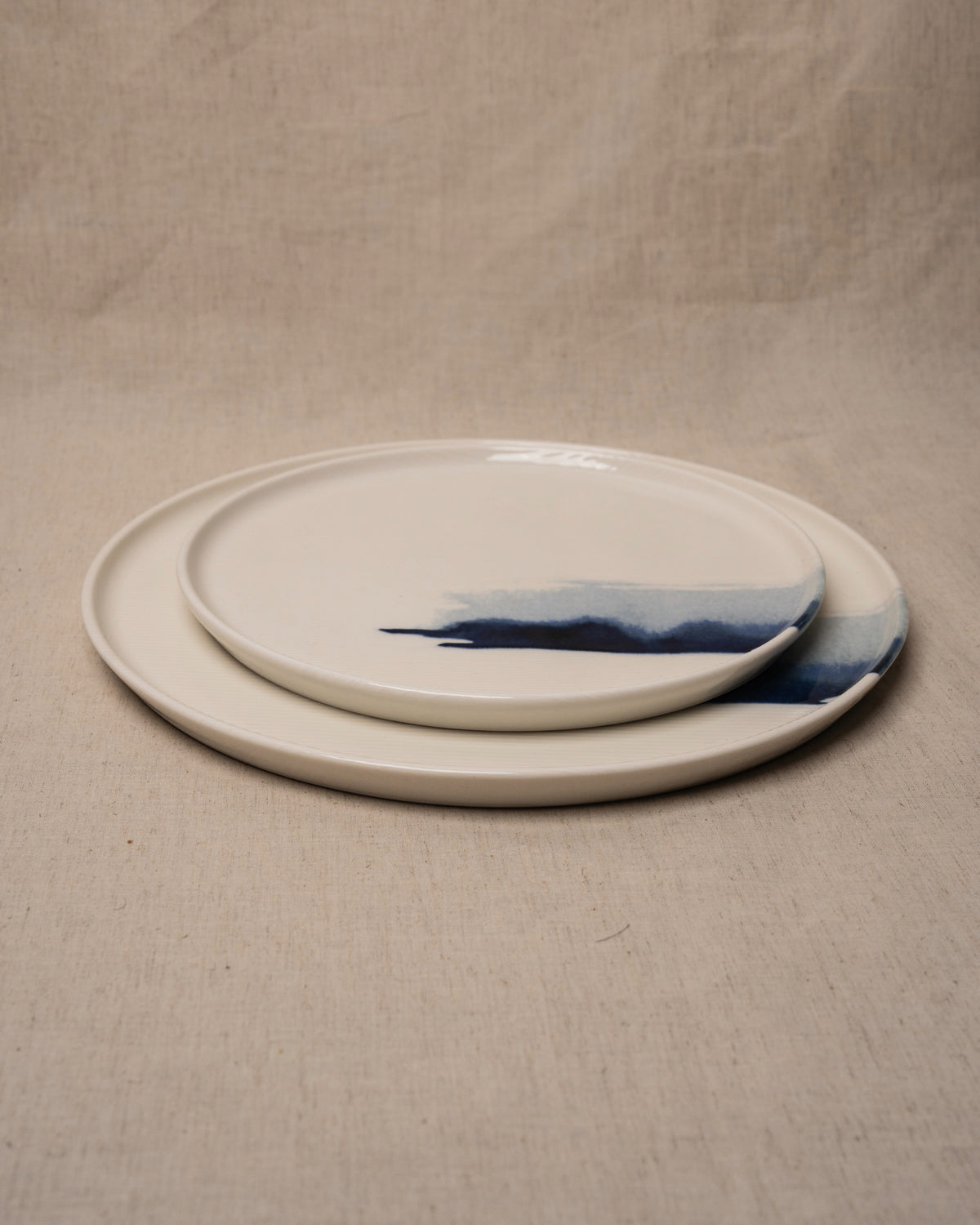 The Wave porcelain plates stacked showing wave rim detail